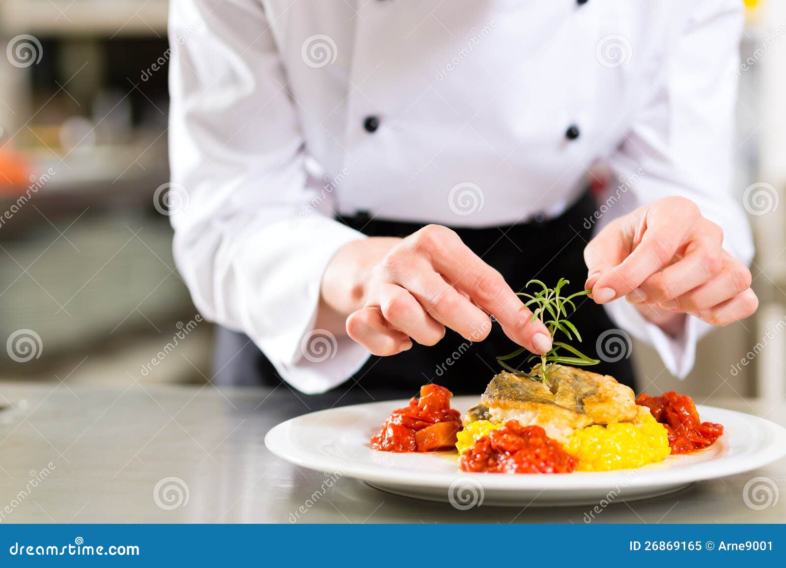 female chef in restaurant kitchen cooking
