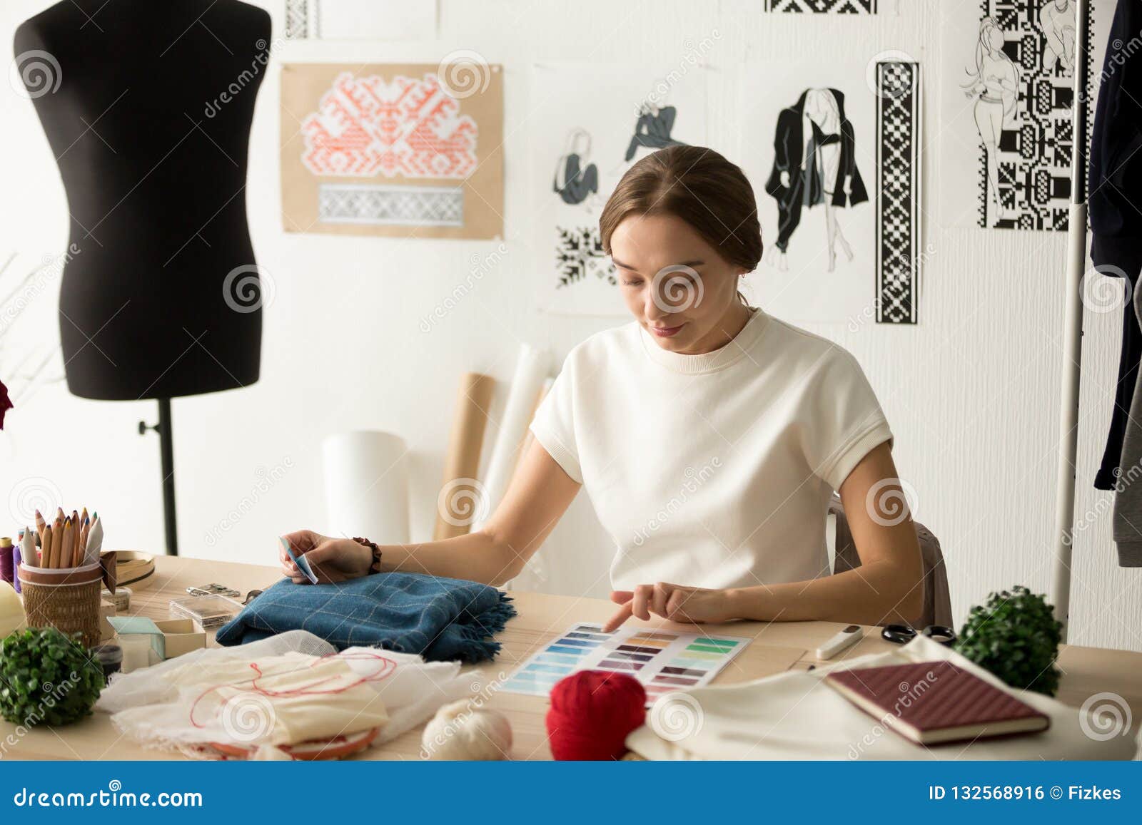 Female Clothes Designer Working with Samples in Workshop Stock Photo ...