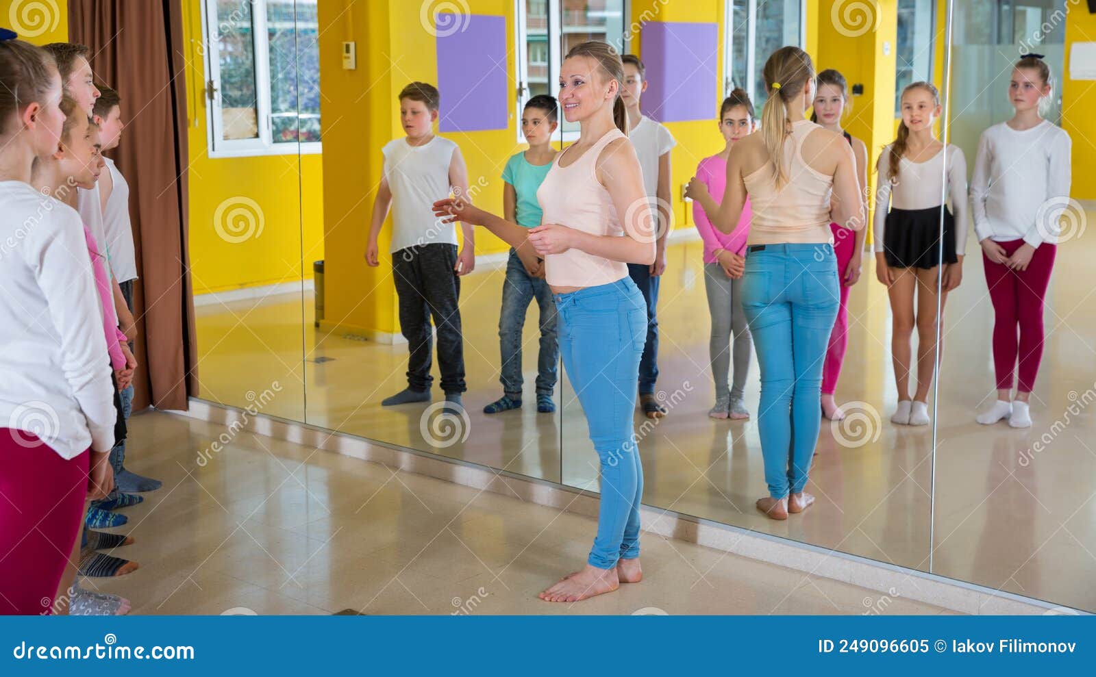 Coach Holding Group Dance Training with Teenagers in Dance Hall Stock