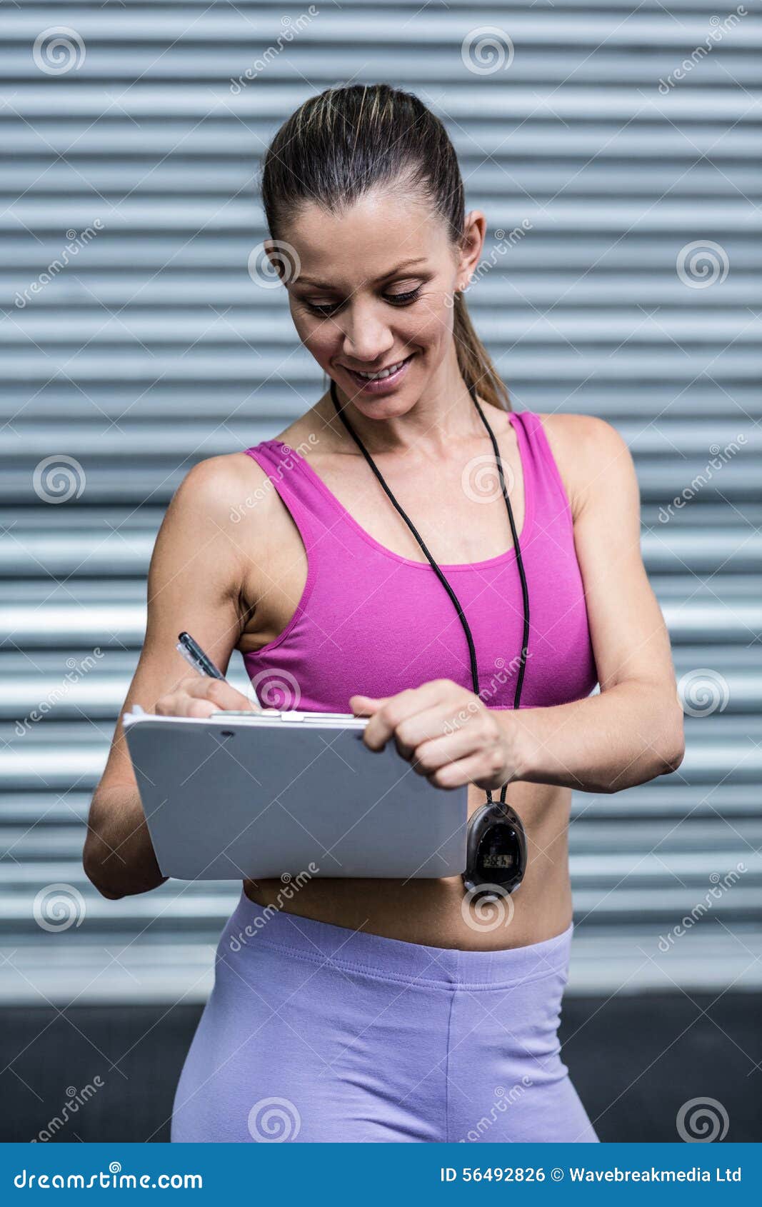 A Female Coach Writing on Her Clipboard Stock Photo - Image of ...