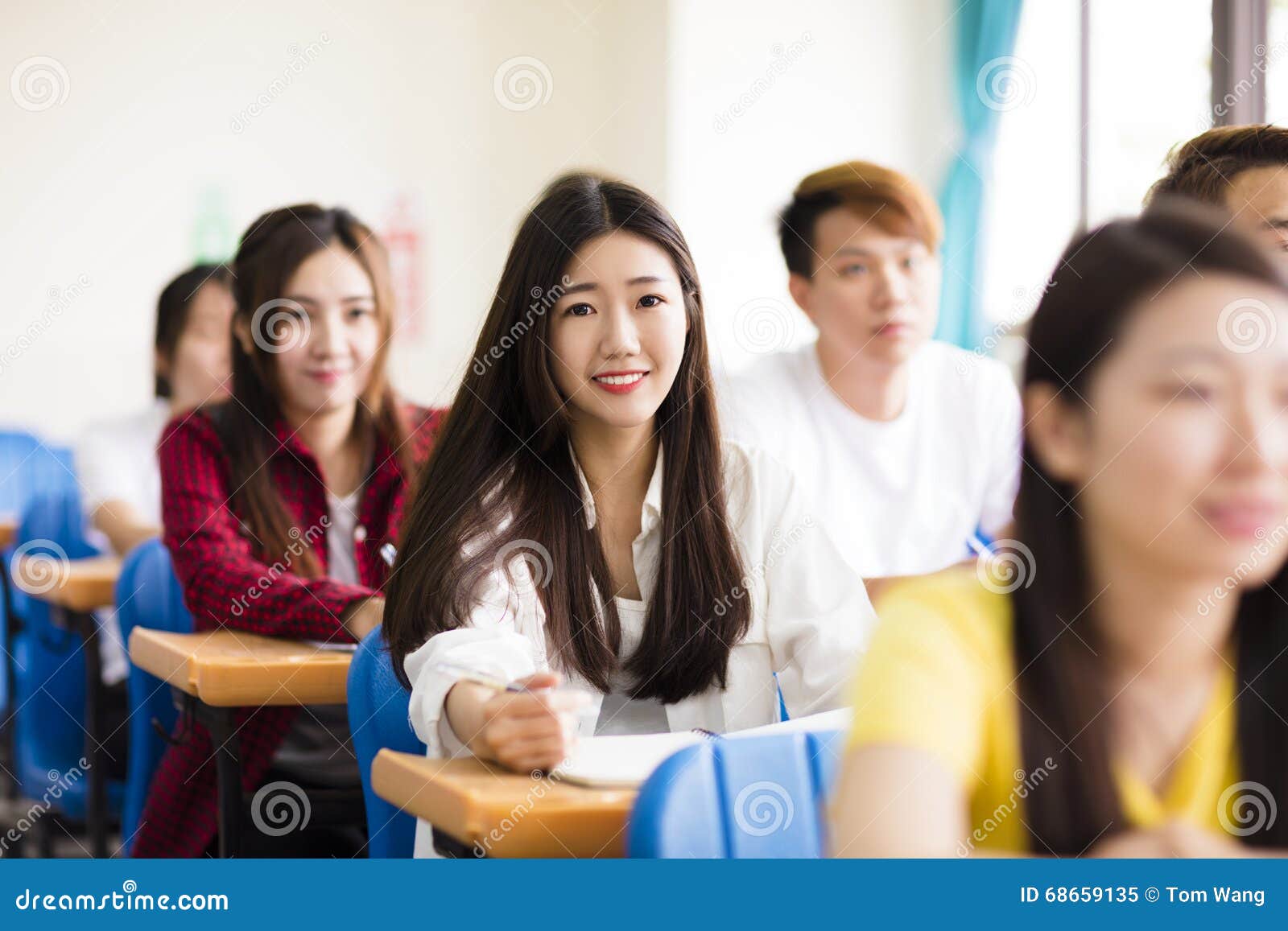 female college student sitting with classmates