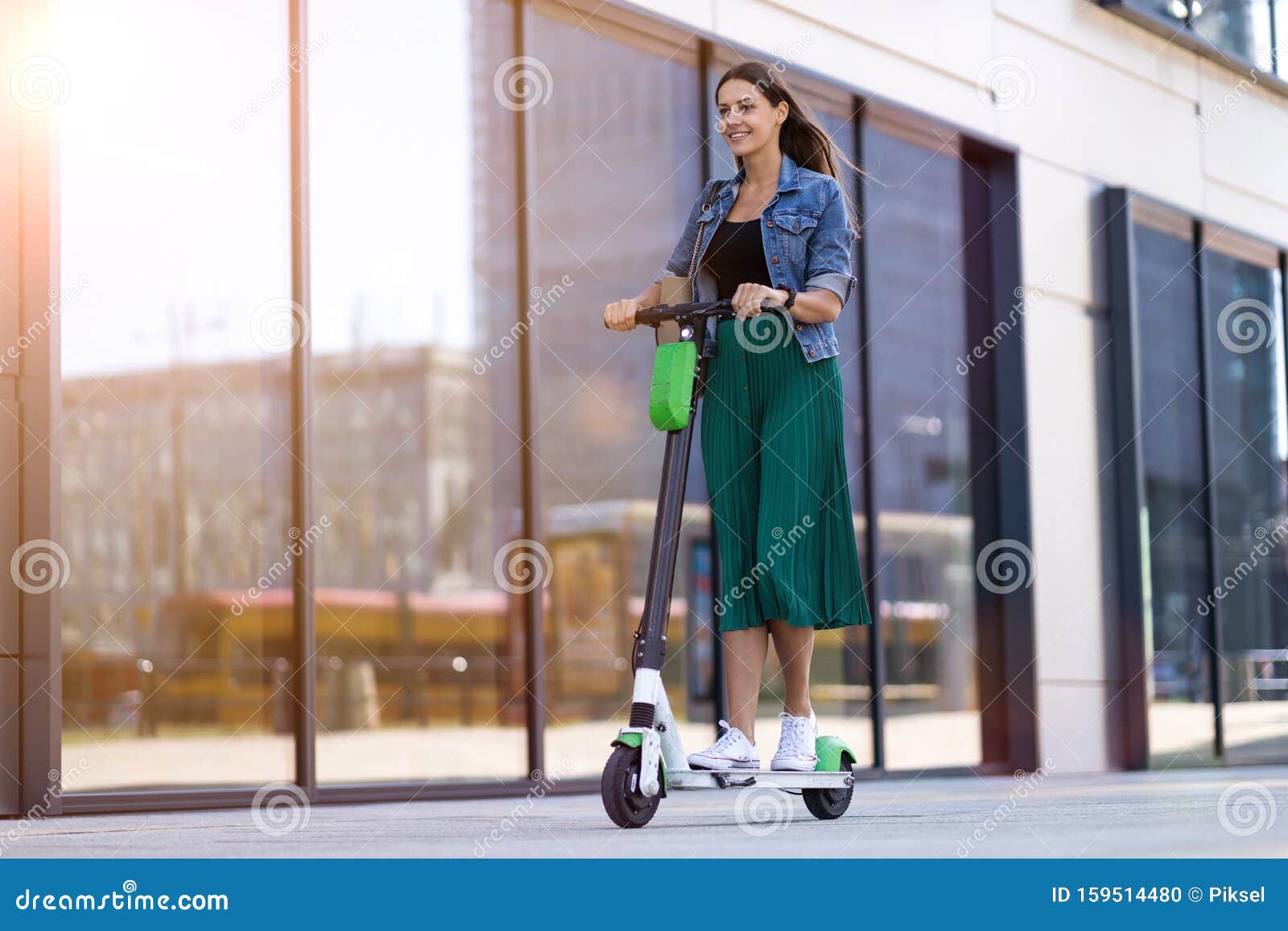 female commuter riding electric push scooter