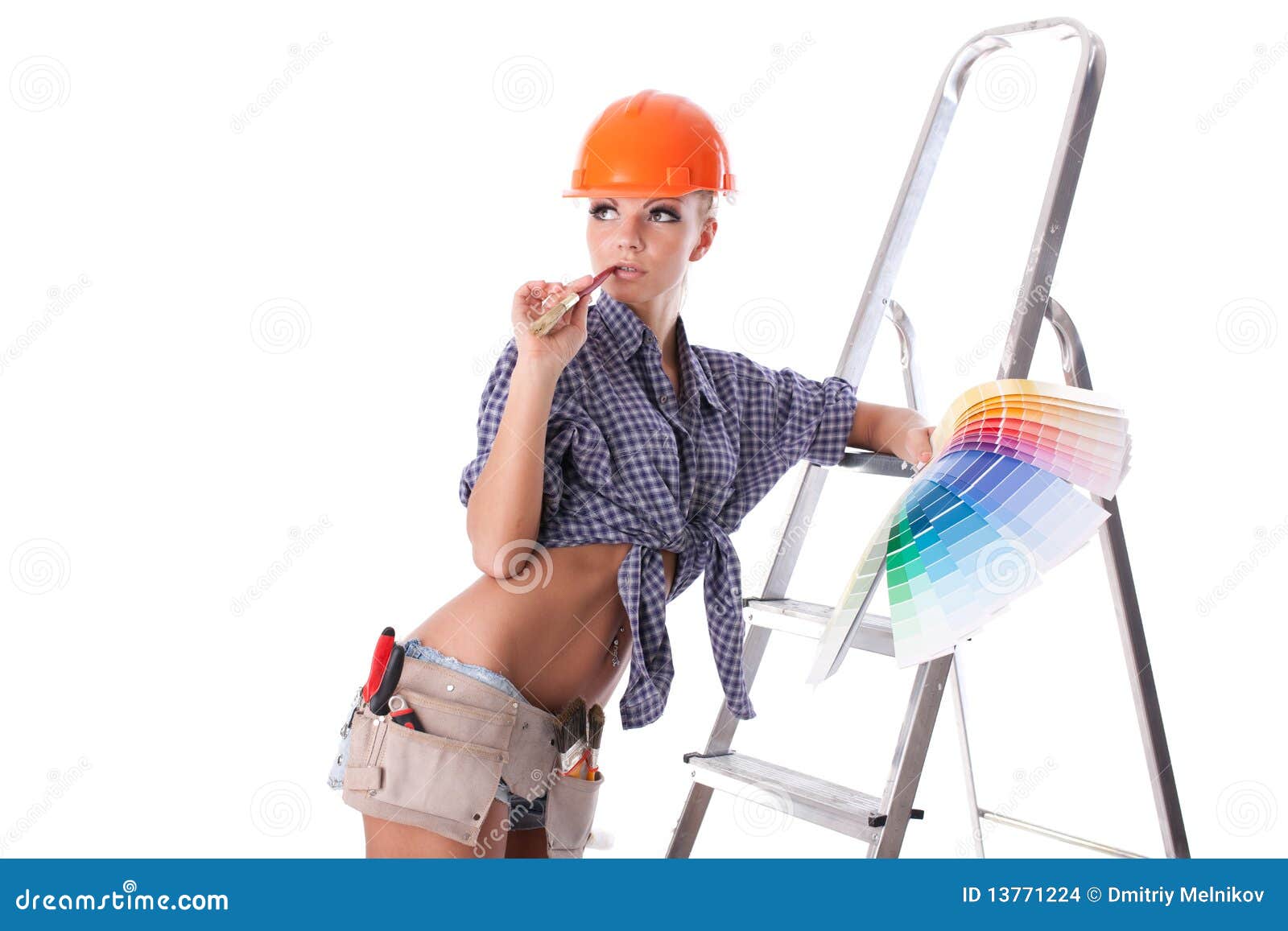 Female construction worker. Young woman in hardhat with a color guide and paintbrush on a white background.