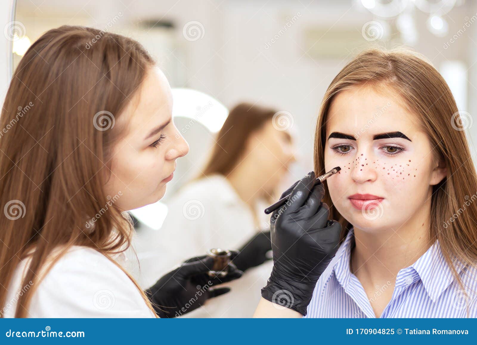 A Female Cosmetologist Performs Eyebrow Correction on a Beautiful Model ...