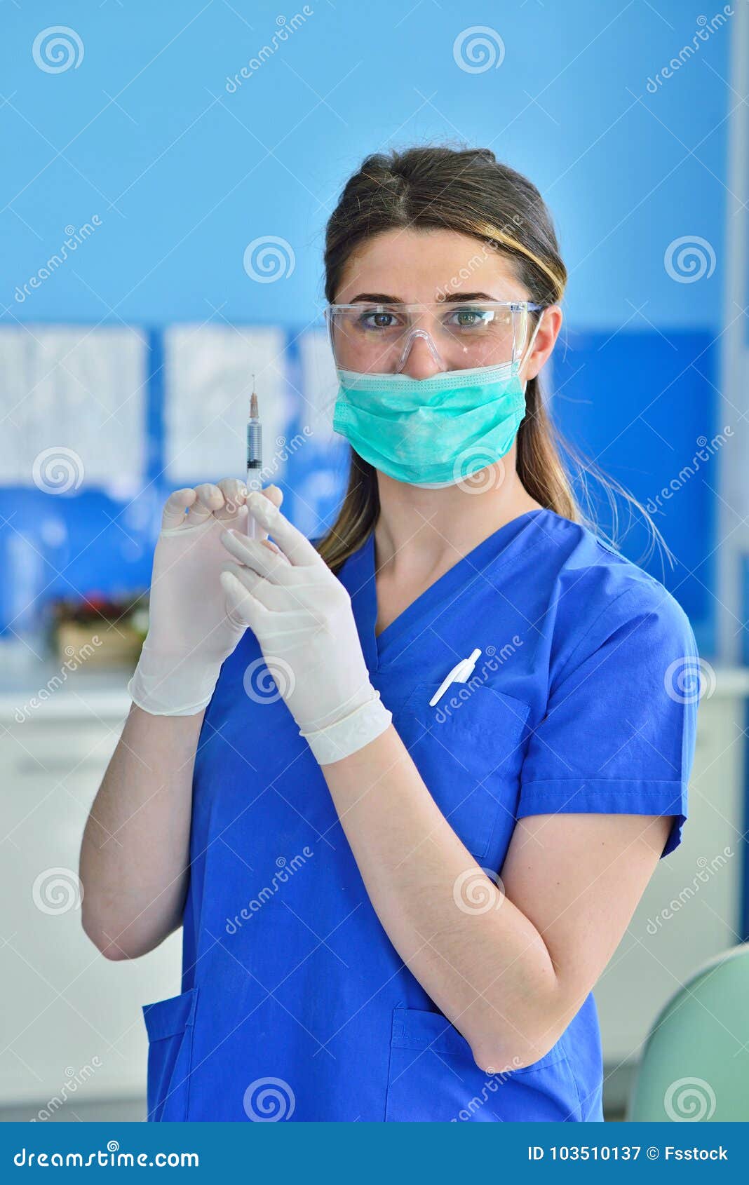 Female Dentist Holding a Dentistry Study Model and a Syringe Stock
