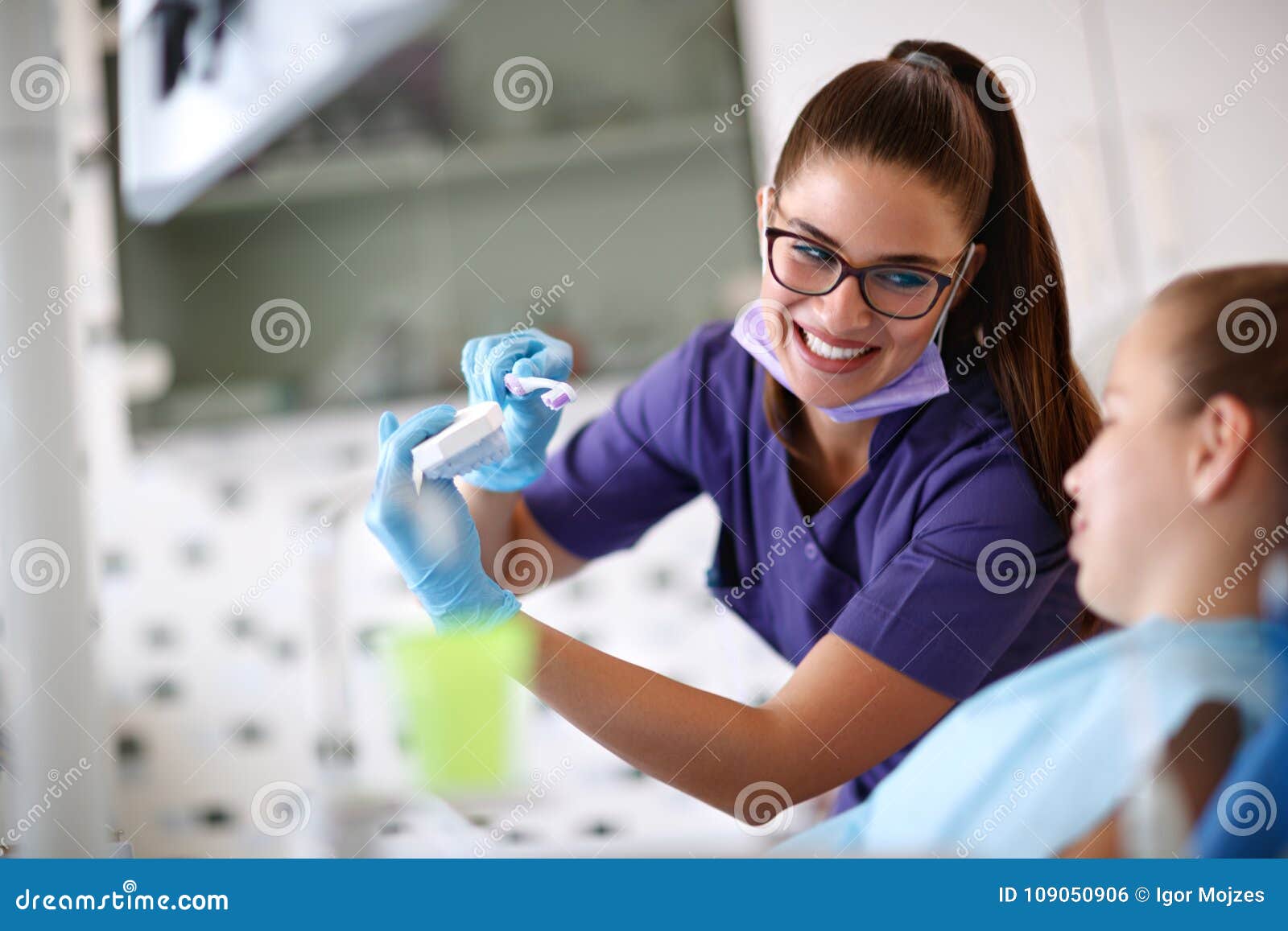 dentist show how to properly brush teeth on jaw model