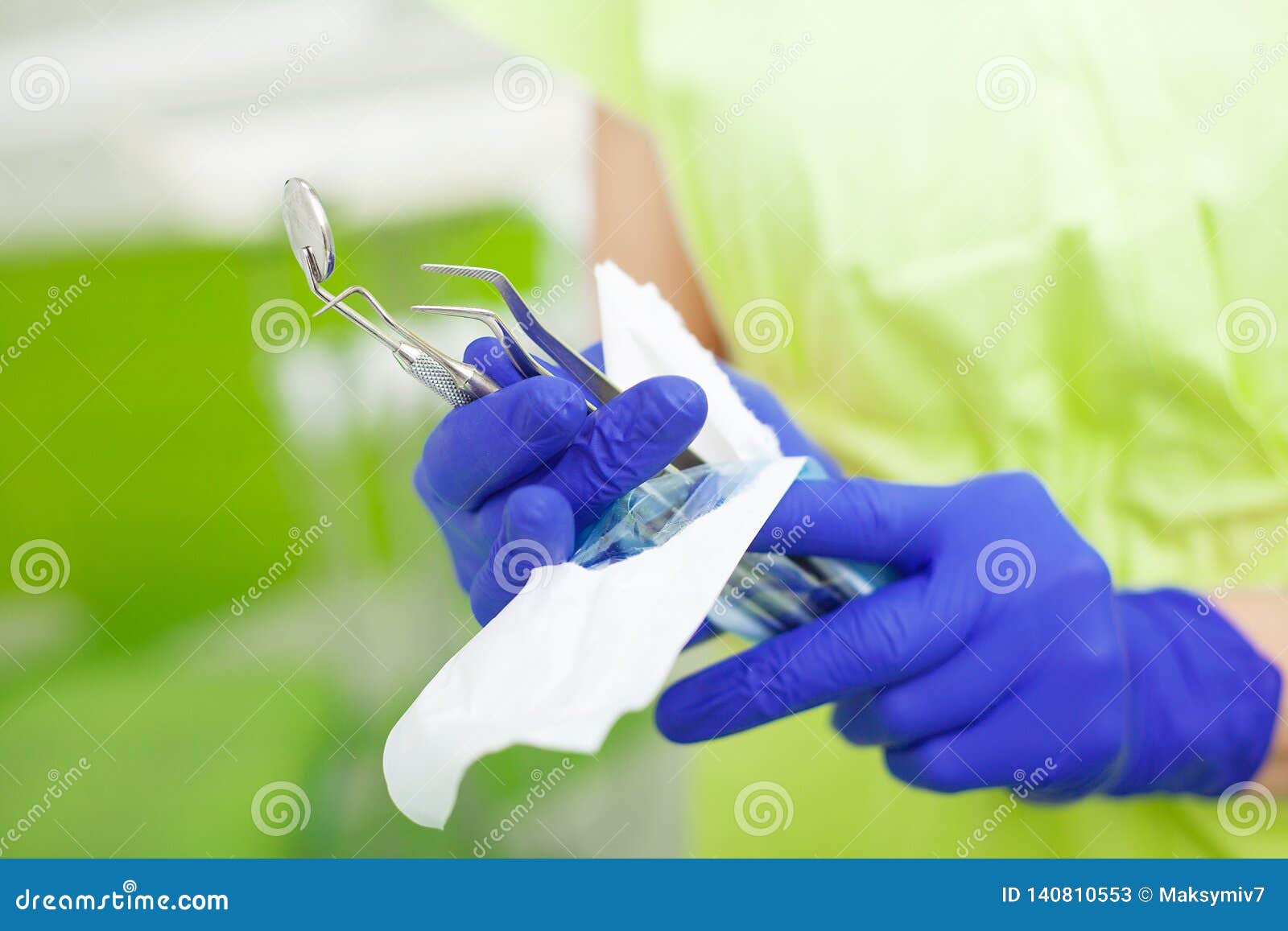 Female Dentist Take Dental Tools Packed in a Protective Foil Stock
