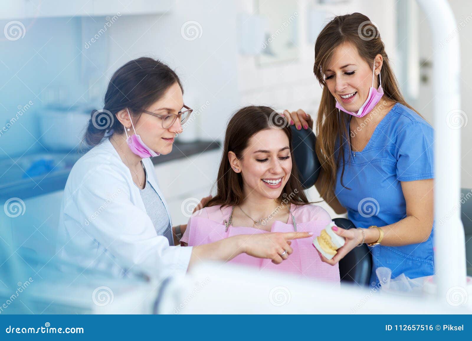 dentists and patient in dentist office