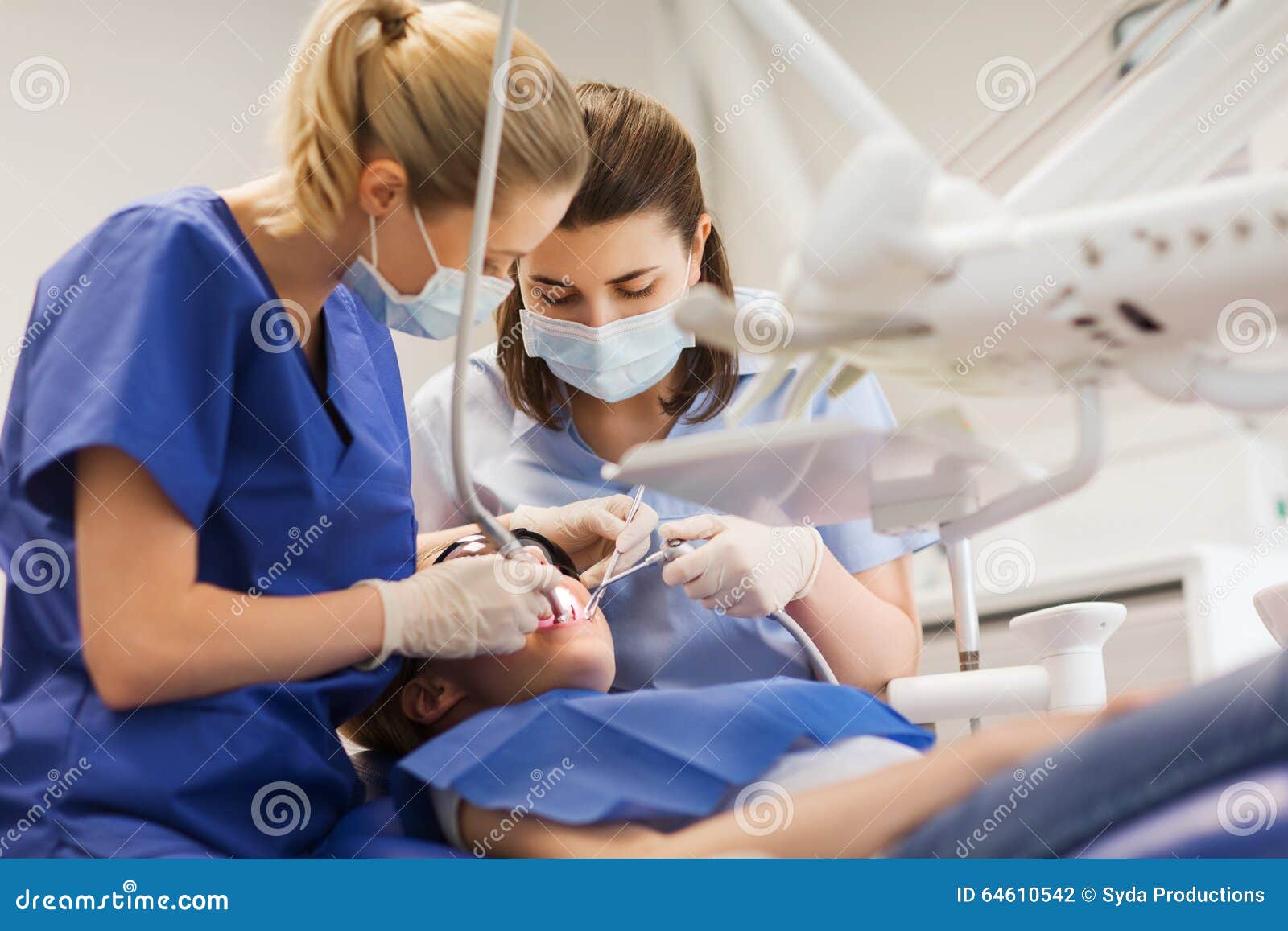 female dentists treating patient girl teeth
