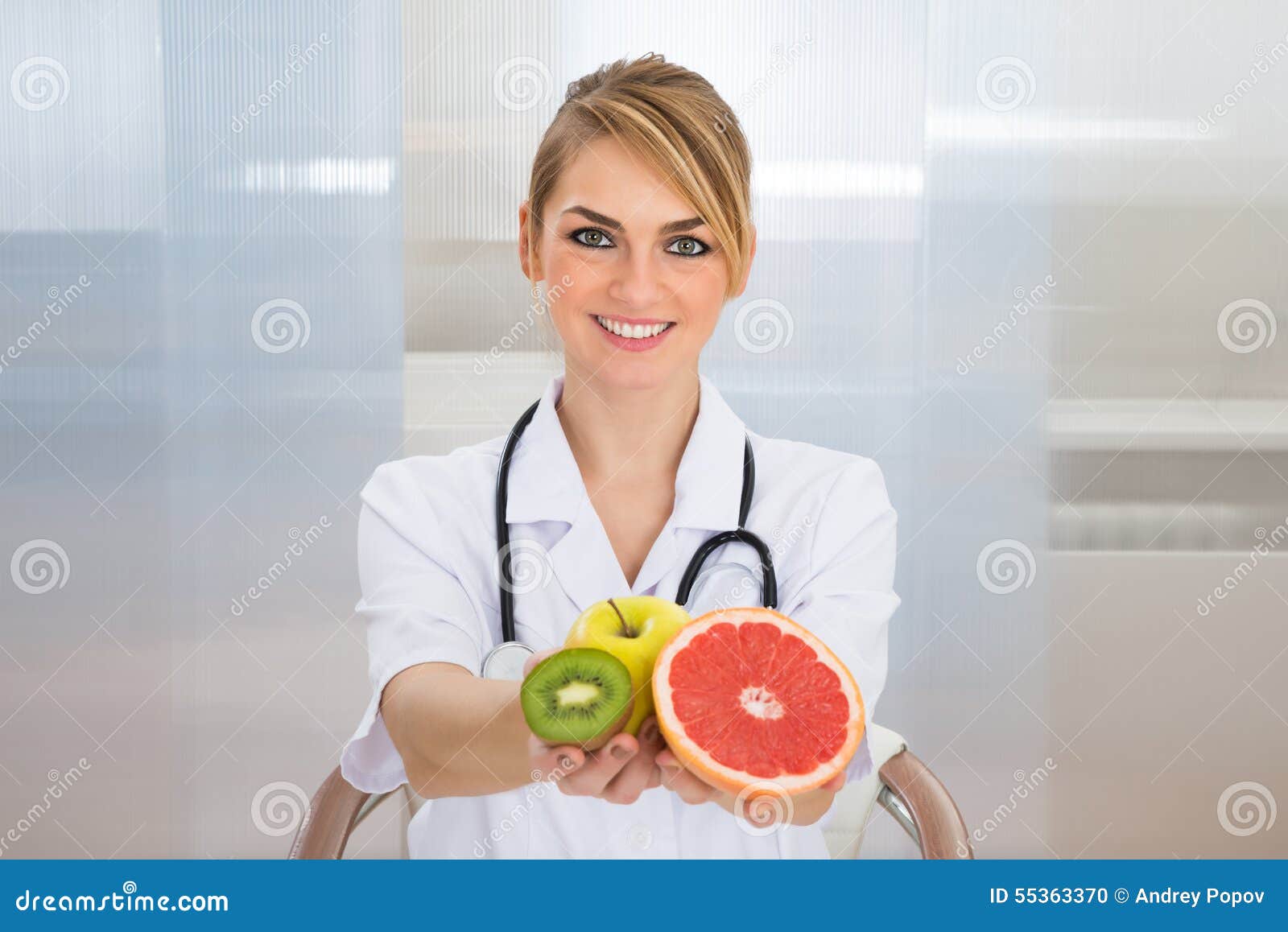female dietician holding fruits