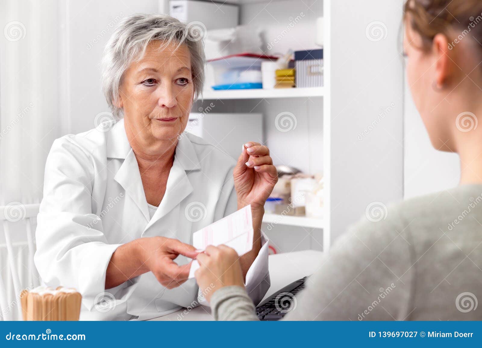 female doctor is giving a medical prescription to a patient, doctorÃÂ´s order