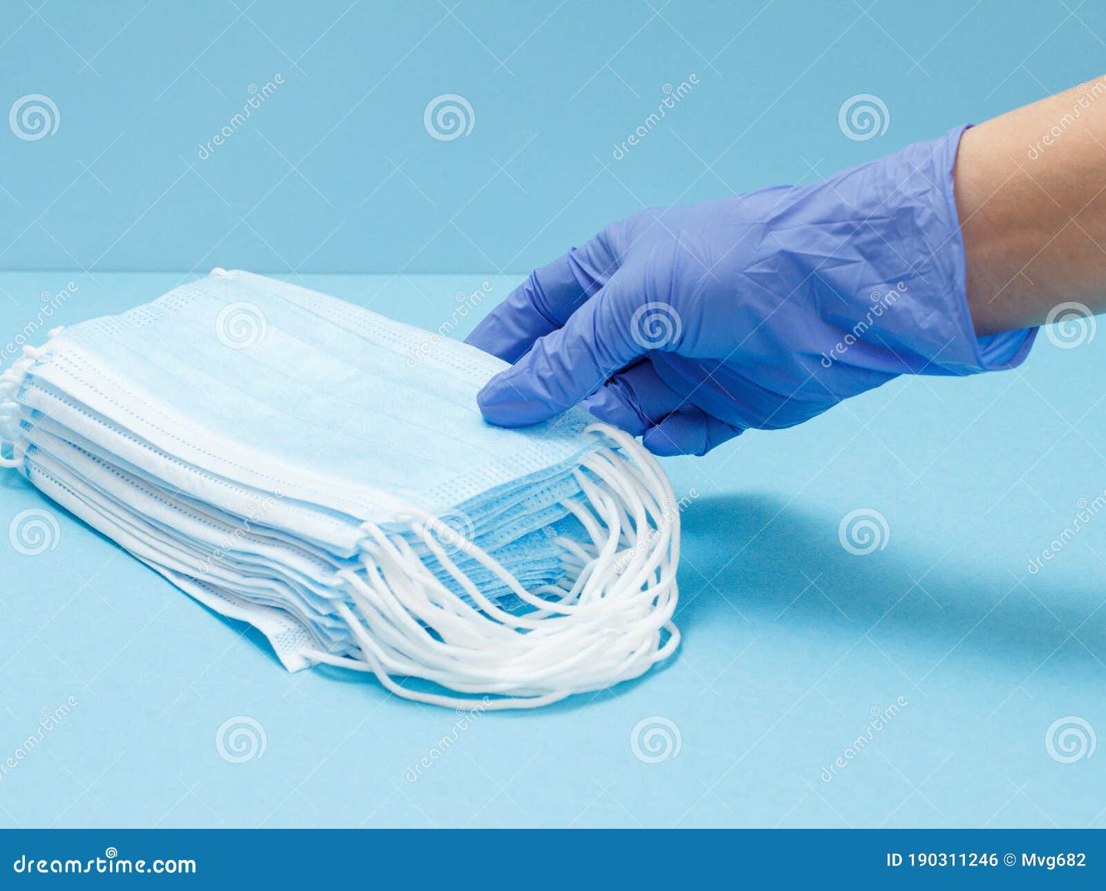 Female Doctor in a Glove with Stacked Medical Masks Stock Photo - Image ...