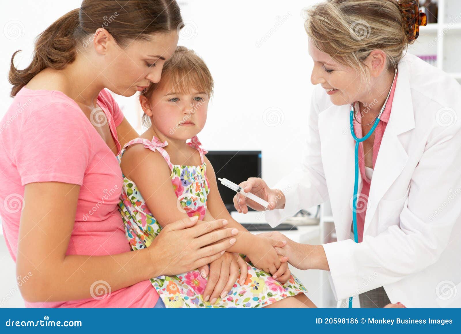 female doctor injecting child