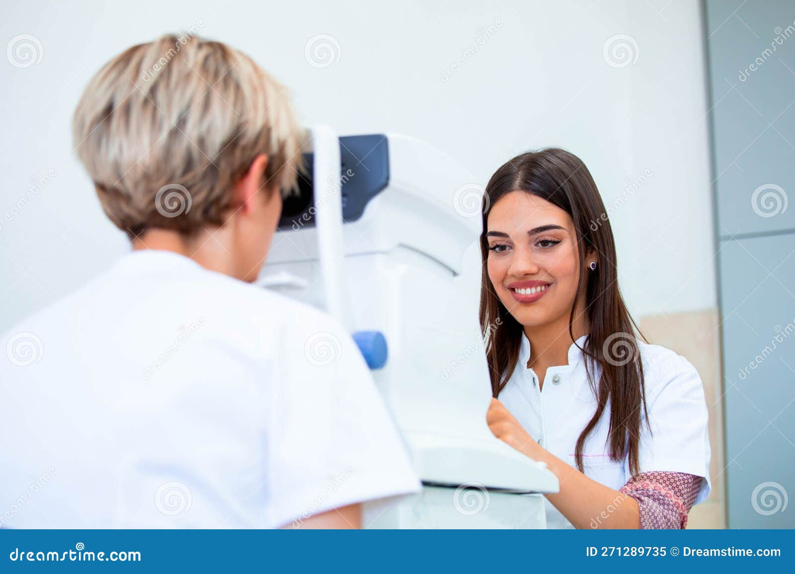 Female Doctor Ophthalmologist is Checking the Eye Vision of Attractive