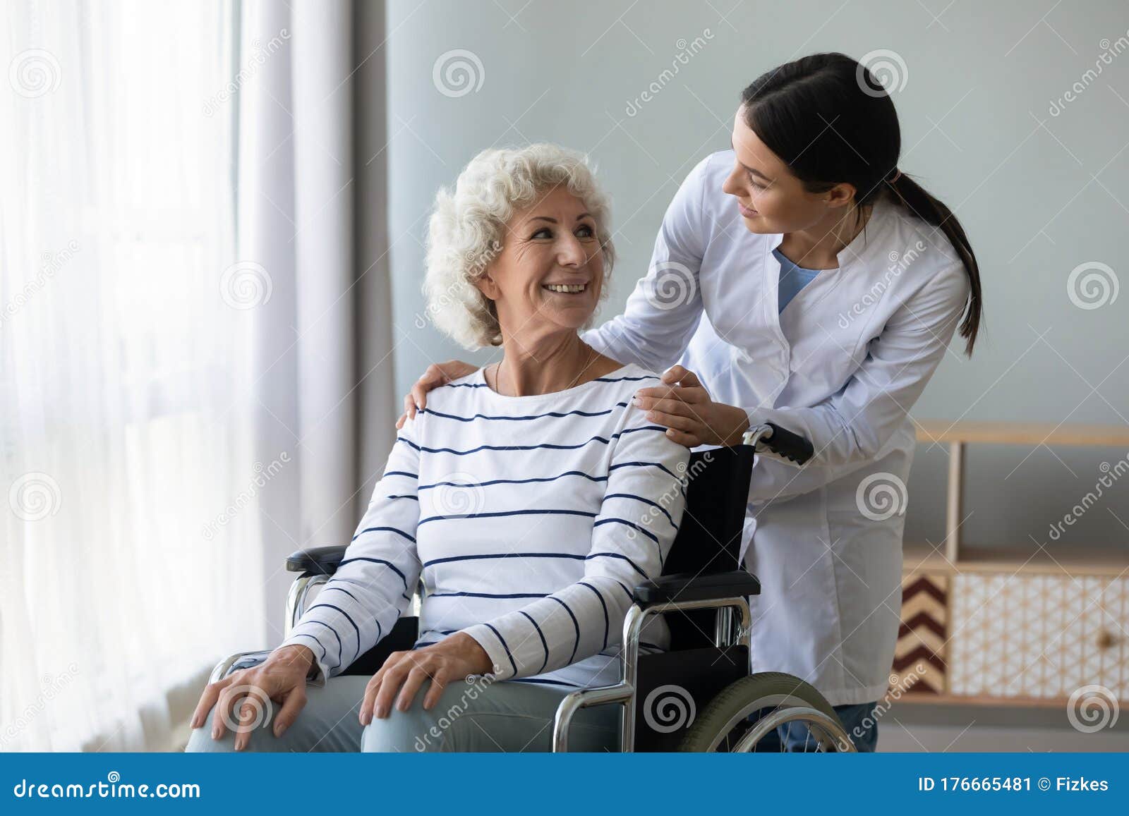 female doctor take care of disabled senior lady