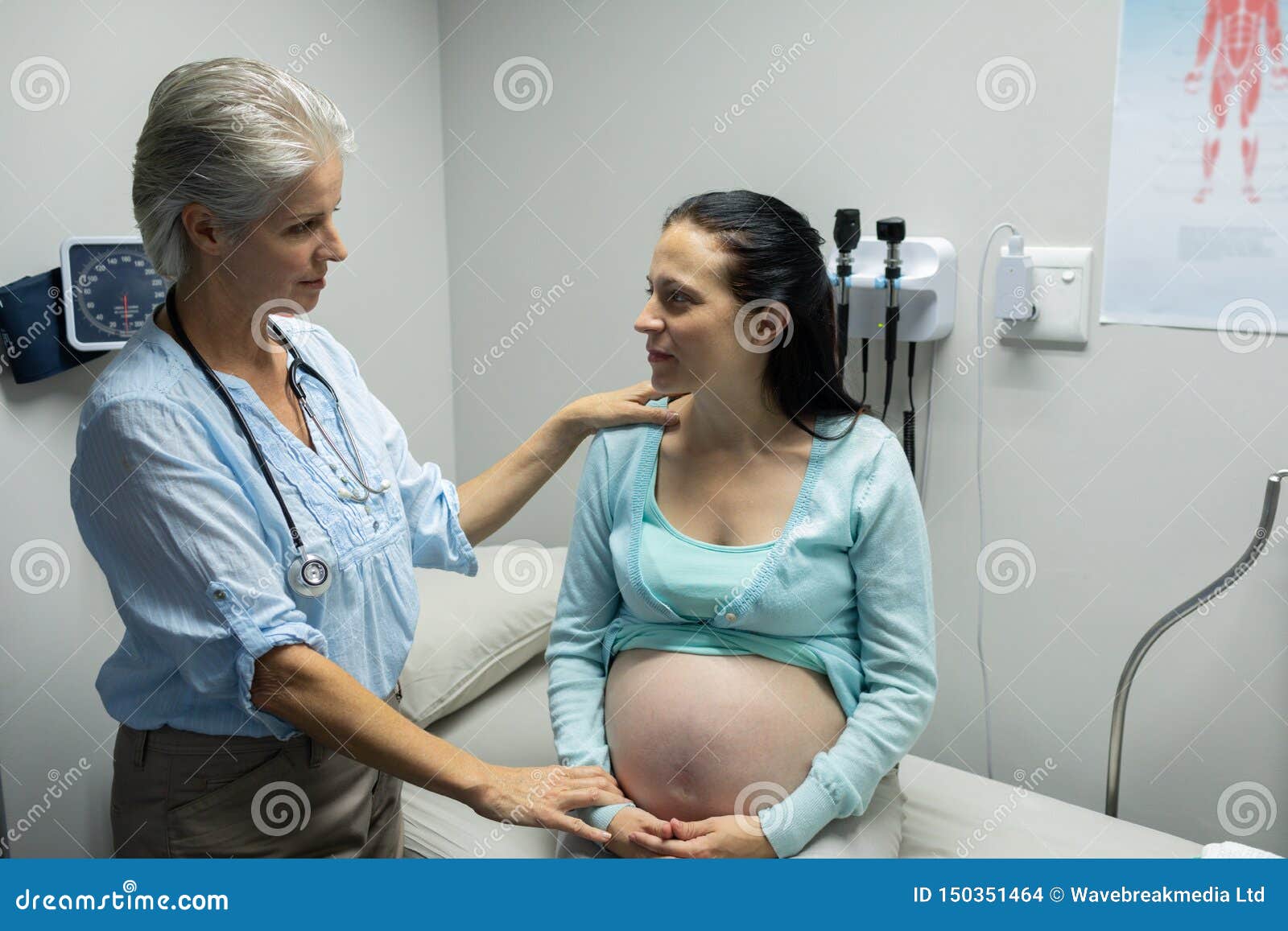 Female Doctor Talking With Pregnant Woman In Examination Room Stock 