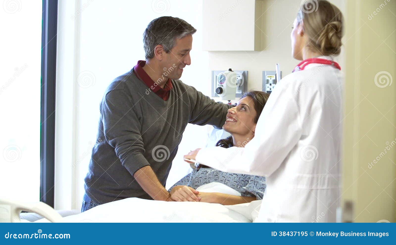 Female Doctor Talks To Husband and Wife photo