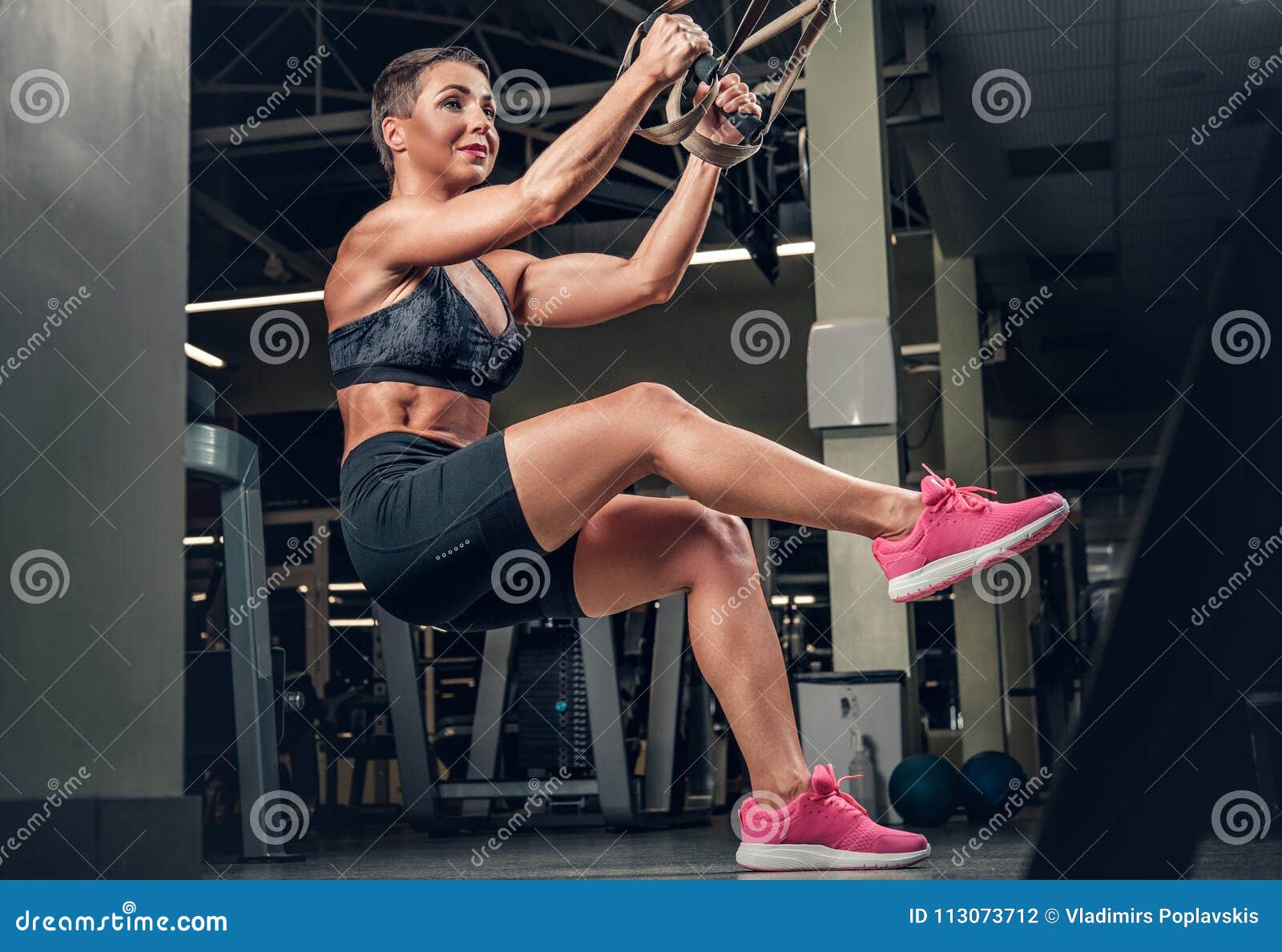 Female Doing Workouts With Trx Suspension Strips In A Gym Club Stock