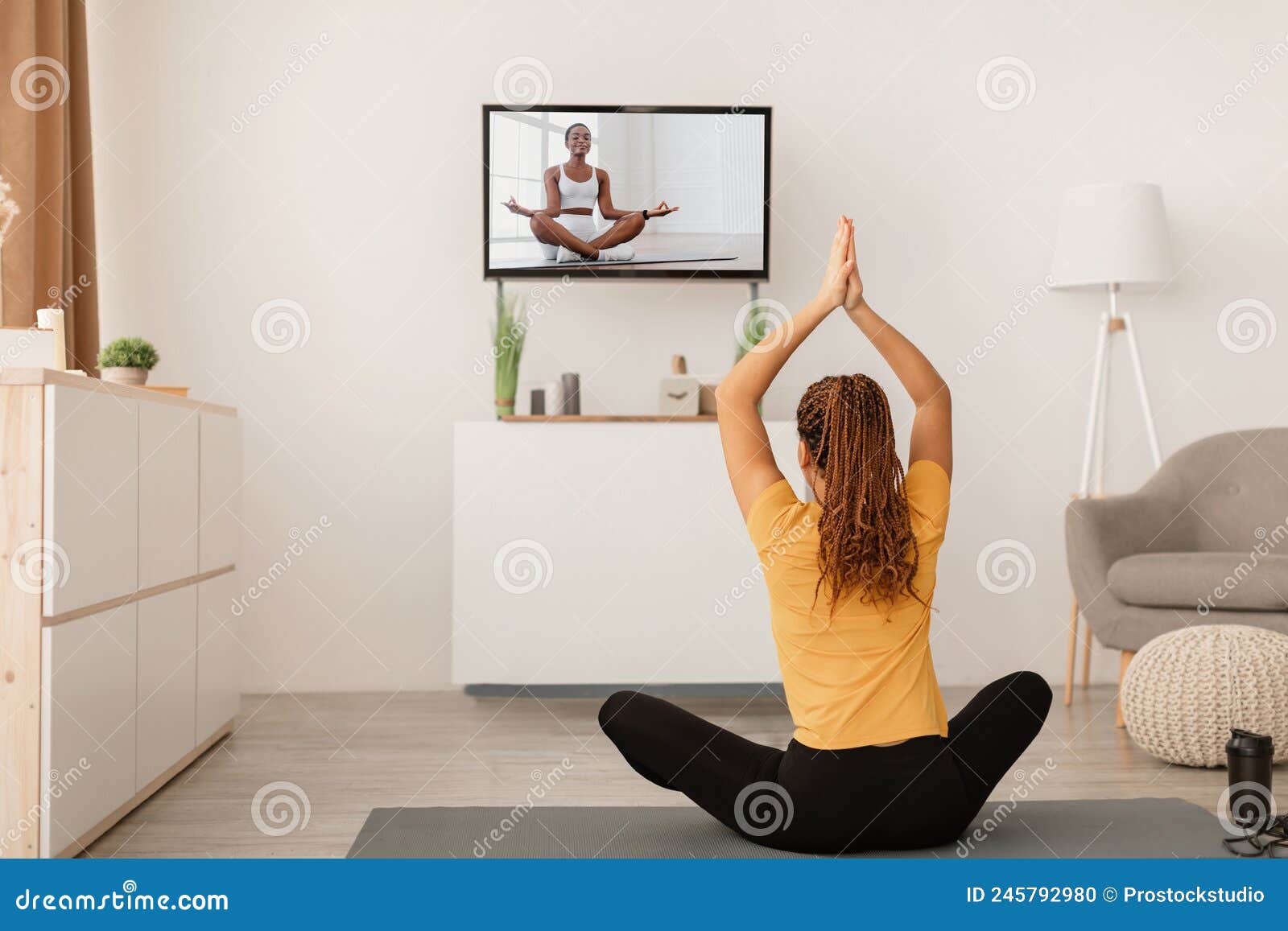 Female Doing Yoga Watching TV Sitting in Lotus Position Indoor Stock Photo  - Image of home, instructor: 245792980