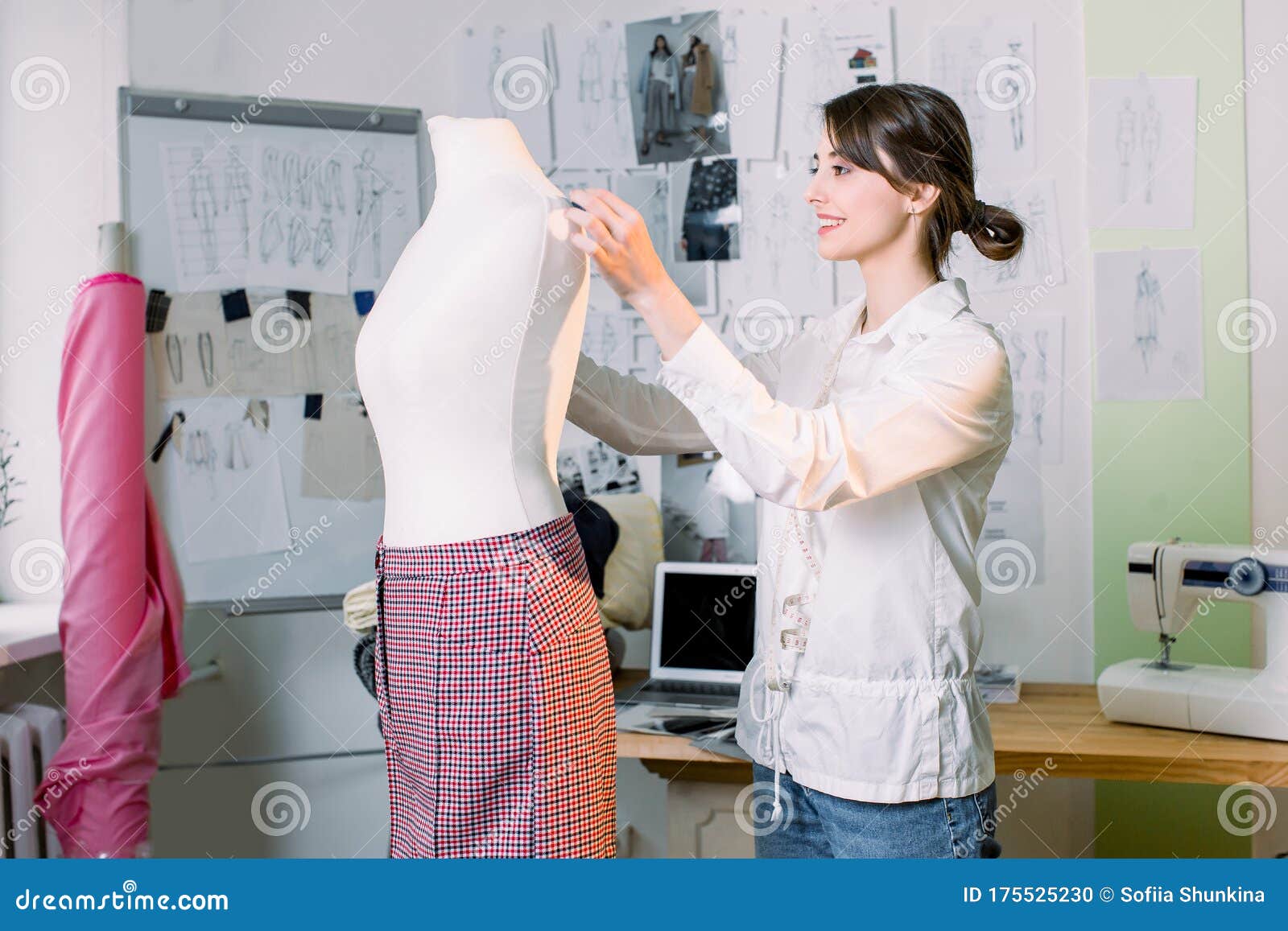 Female Dressmaker Working on New Model Tailoring Pants on Mannequin in ...