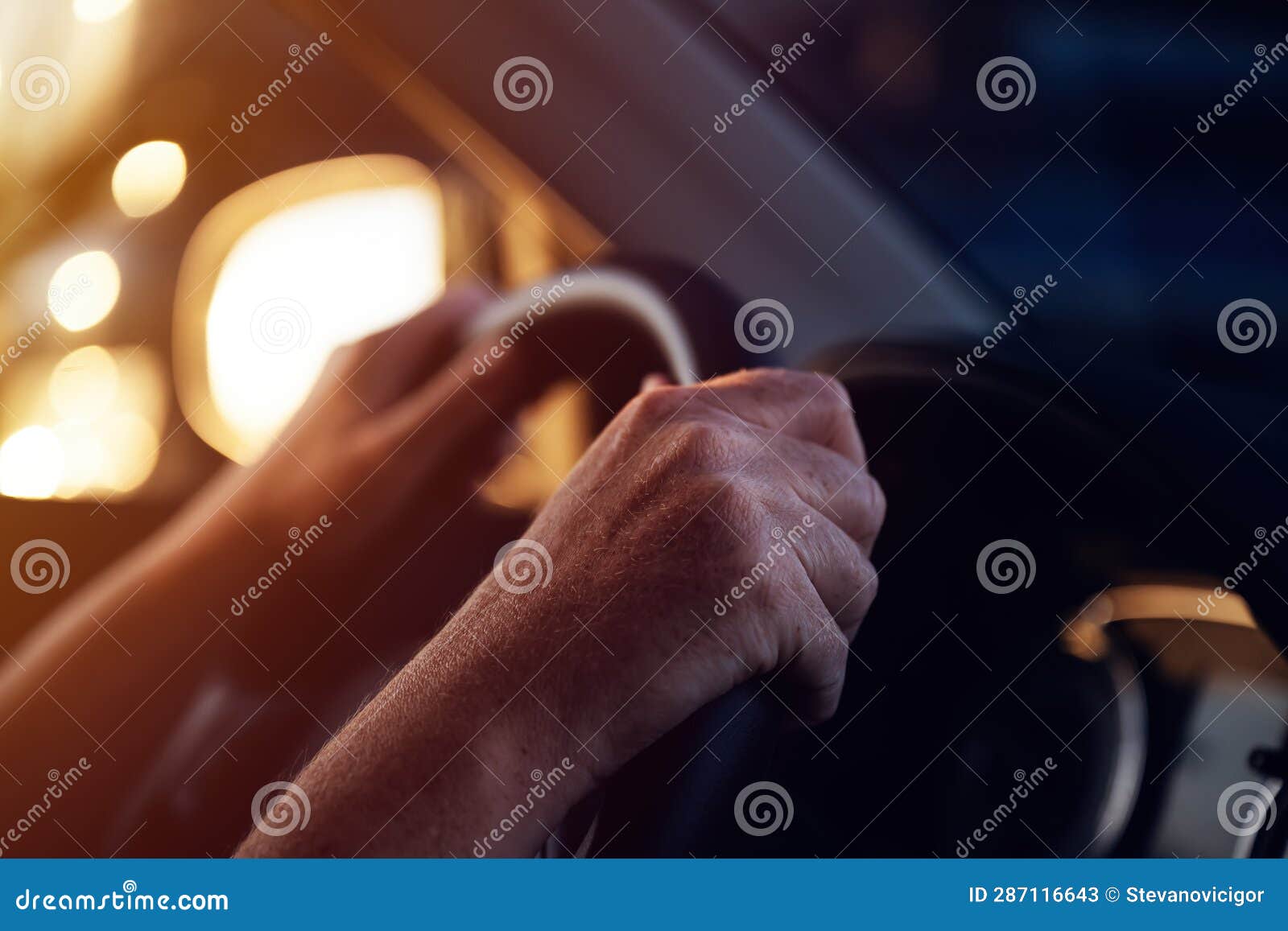female driver holding firmly car steering wheel while driving her vehicle in sunset