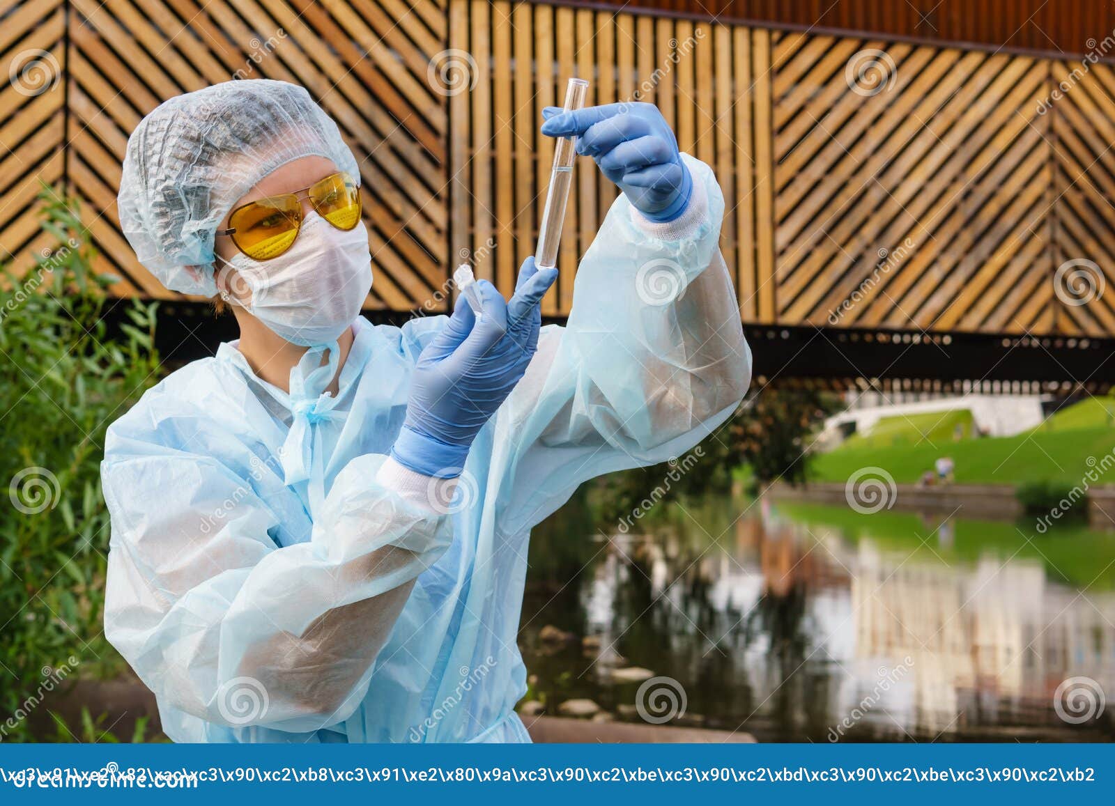 female ecologist or epidemiologist checks water quality in urban pond