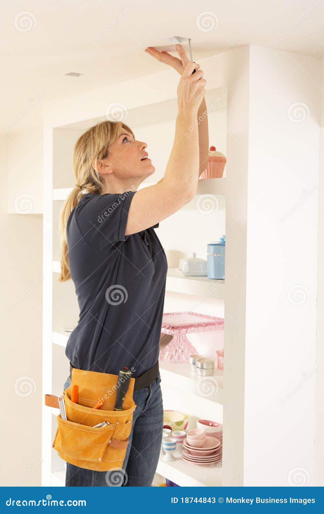 Female Electrician Installing Light
