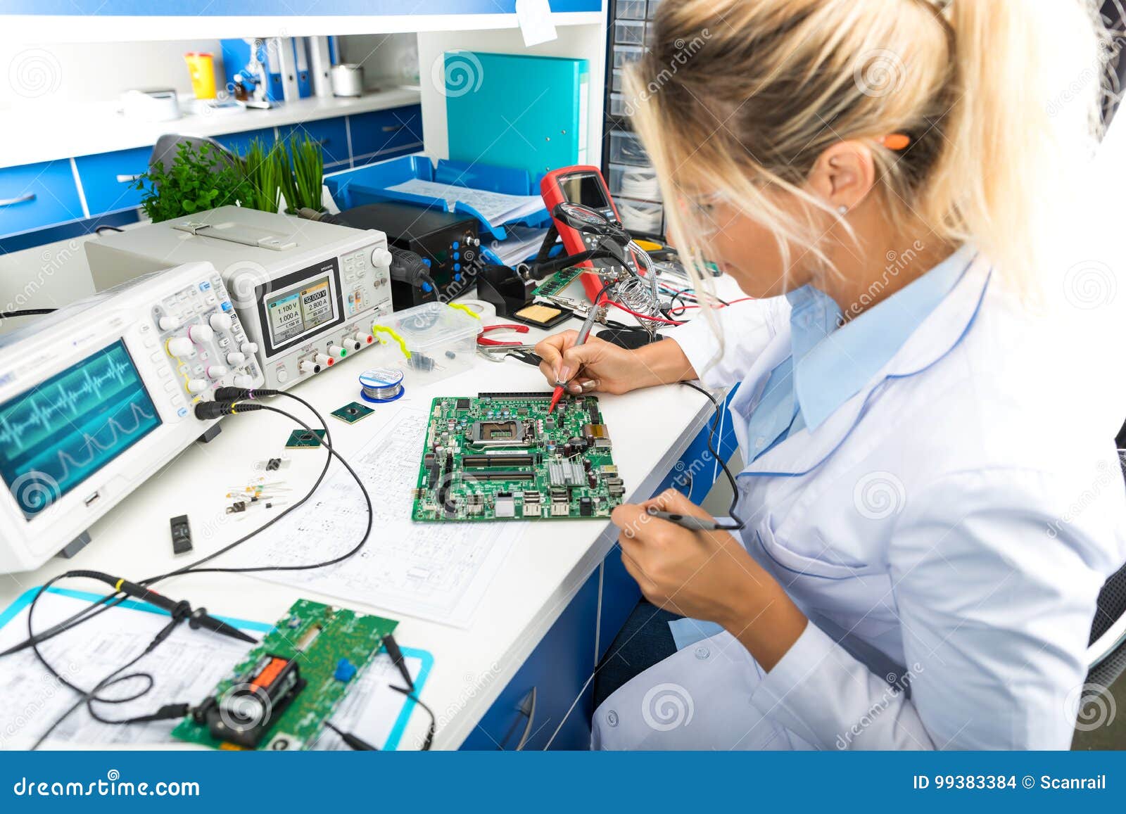 female electronic engineer testing computer motherboard in labor