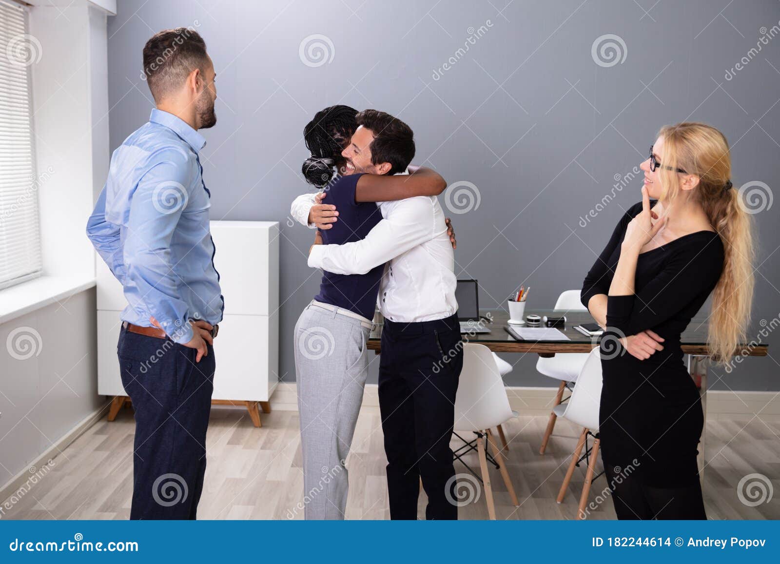 female employee hugging embracing happy coworker