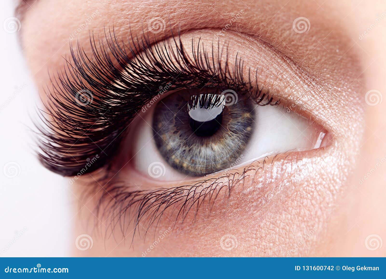 female eye with long false eyelashes