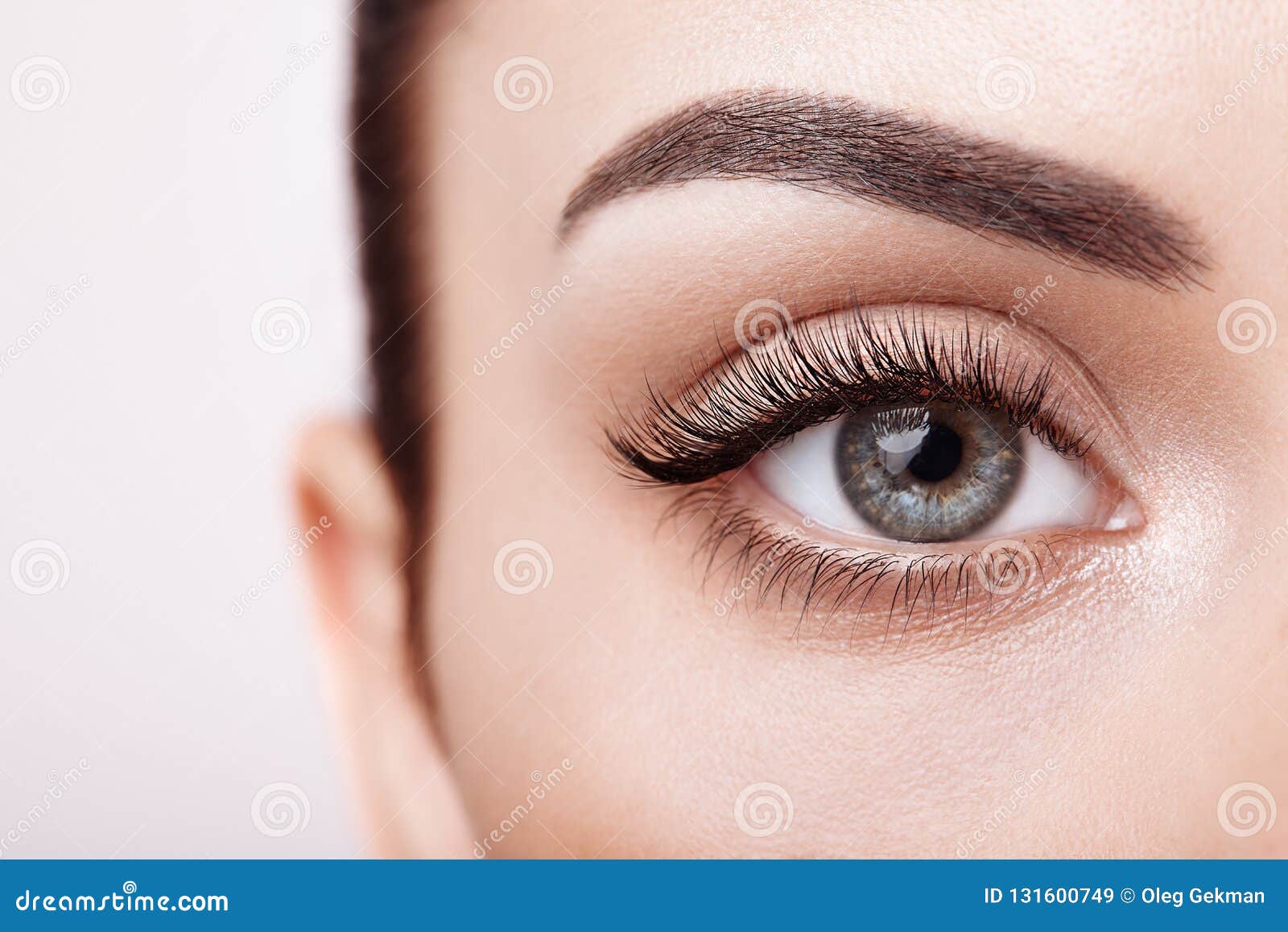 female eye with long false eyelashes