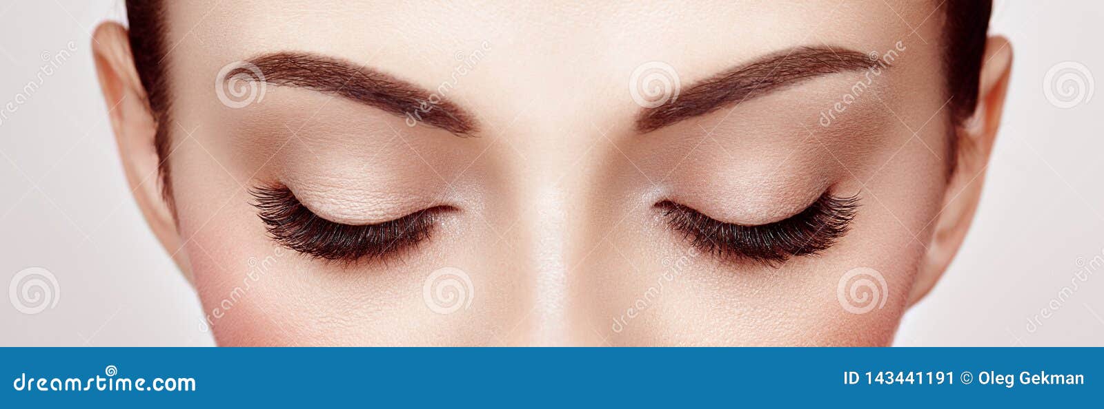 female eye with long false eyelashes