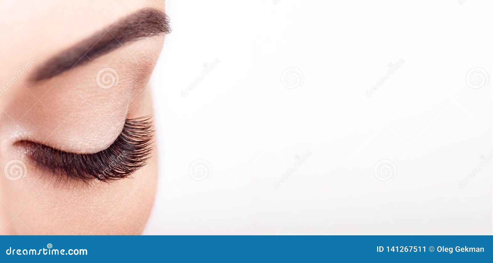 female eye with long false eyelashes