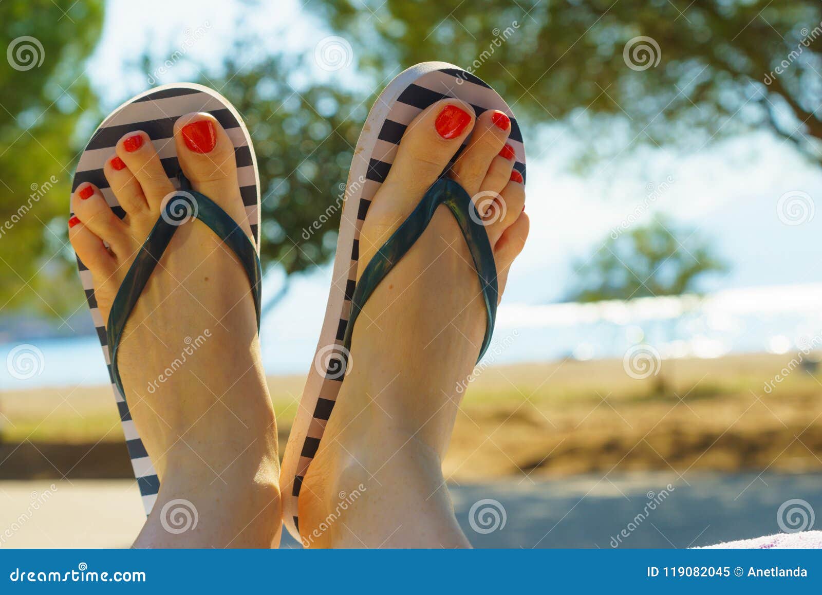 Female Feet Wearing Flip Flops Having Red Nails Stock Image - Image of ...