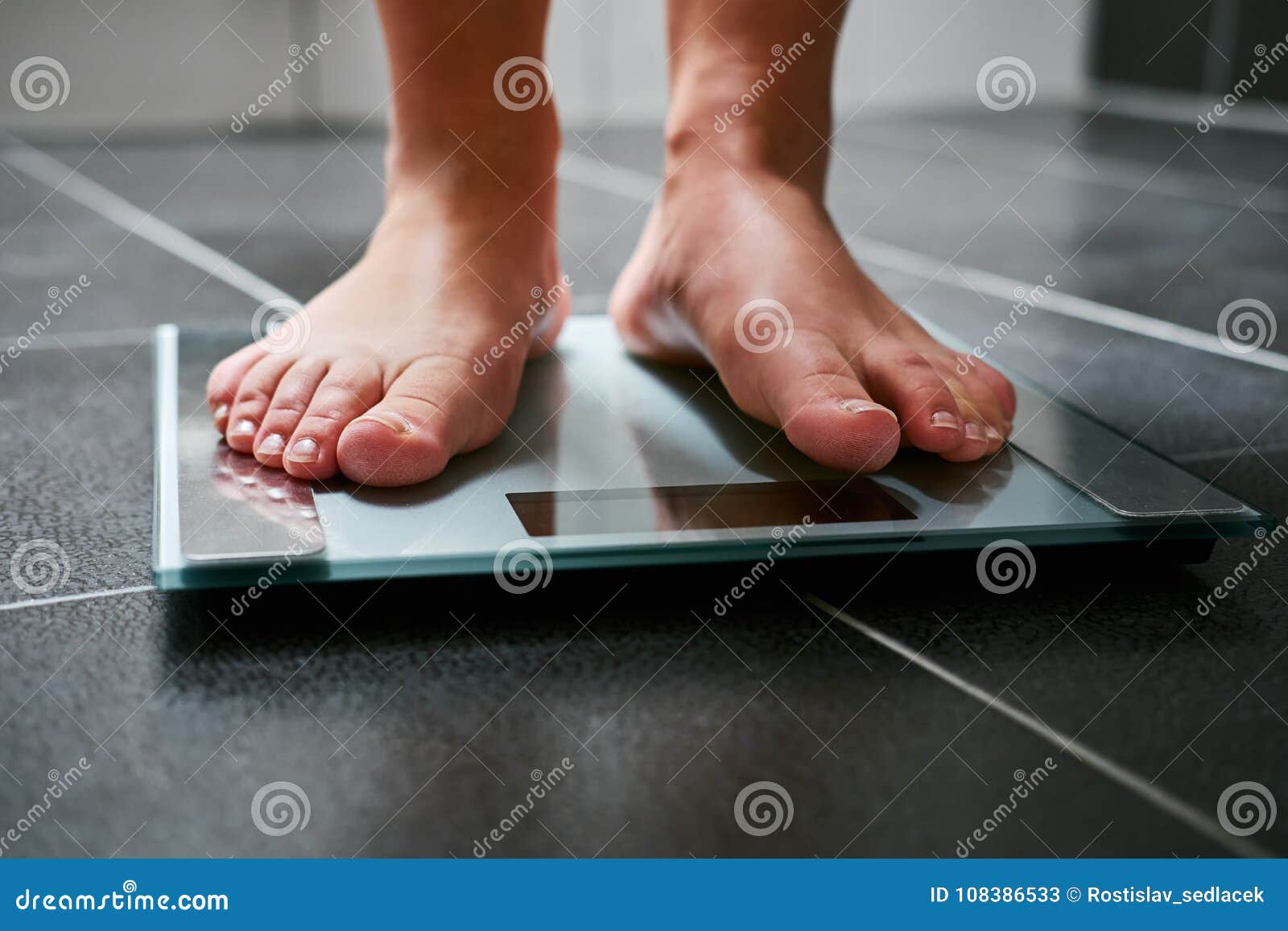 The Feet Of A Woman Standing On Bathroom Scales To Turn Stock Photo,  Picture and Royalty Free Image. Image 11153927.