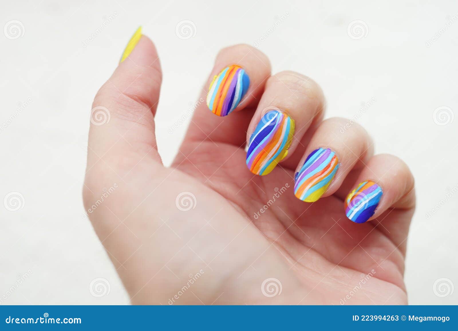 Female Fingers with a Beautiful Striped Manicure. Nail Art with ...