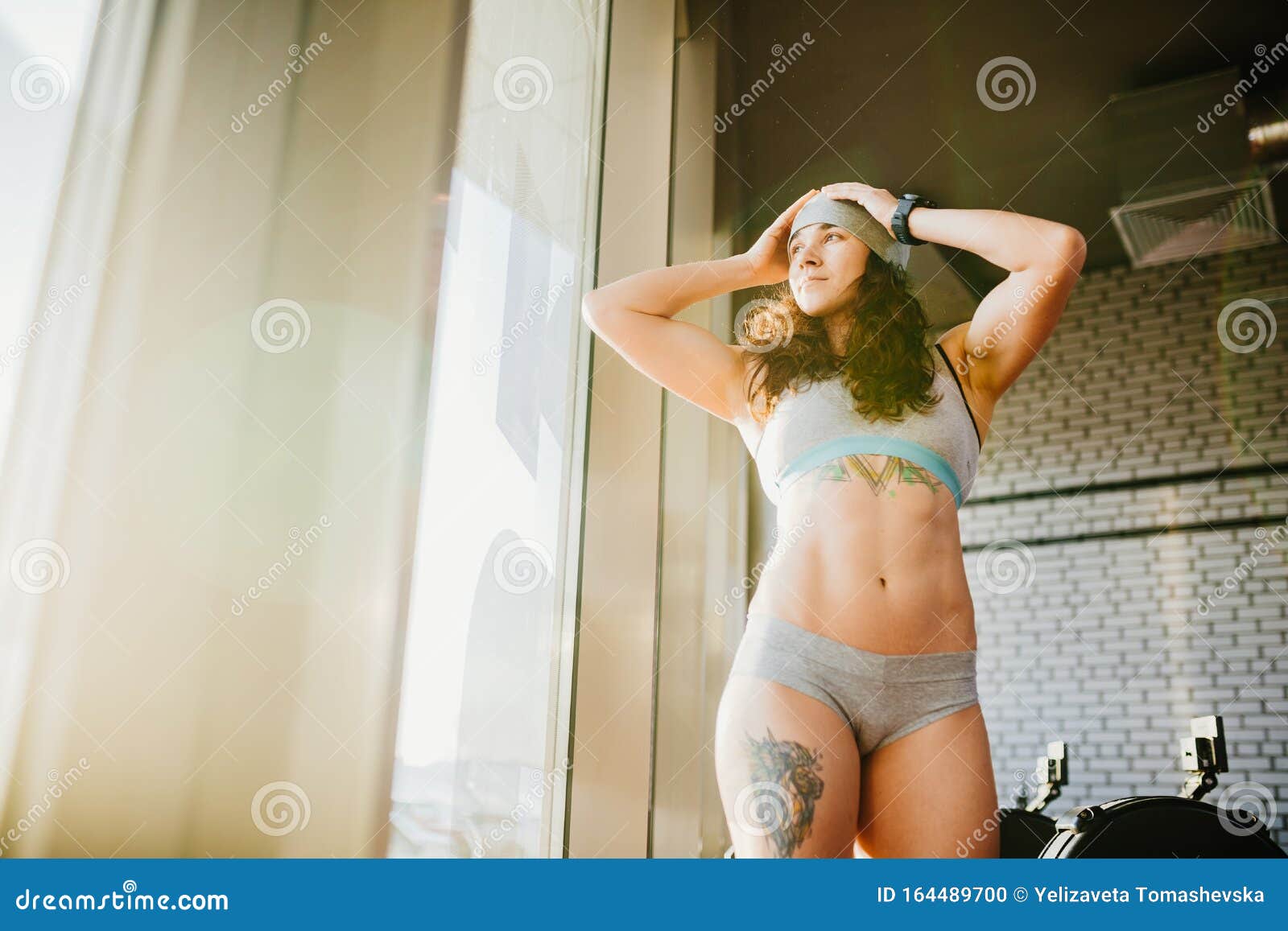 Female Fitness Model in Top Posing Near Big Window pic