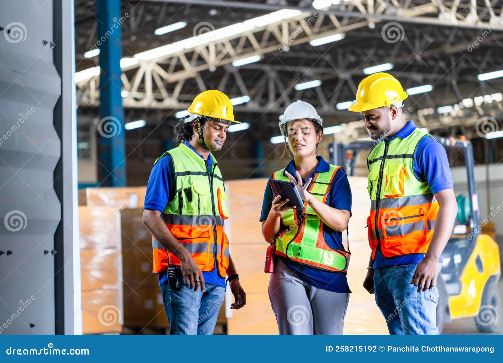 Female Foreperson Making Plans with Warehousemen, Workers Working in