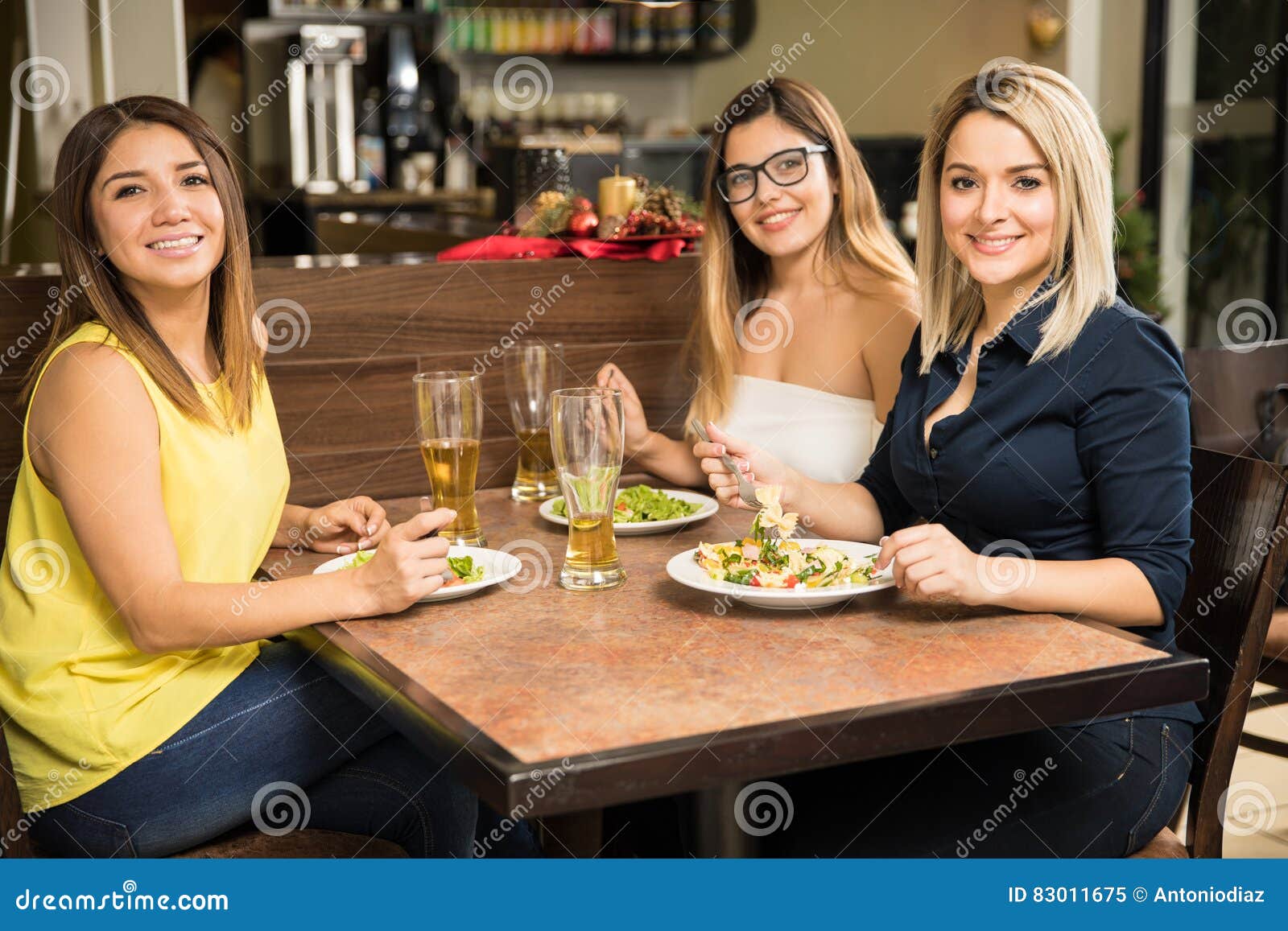 Female Friends Eating in a Restaurant Stock Image - Image of casual