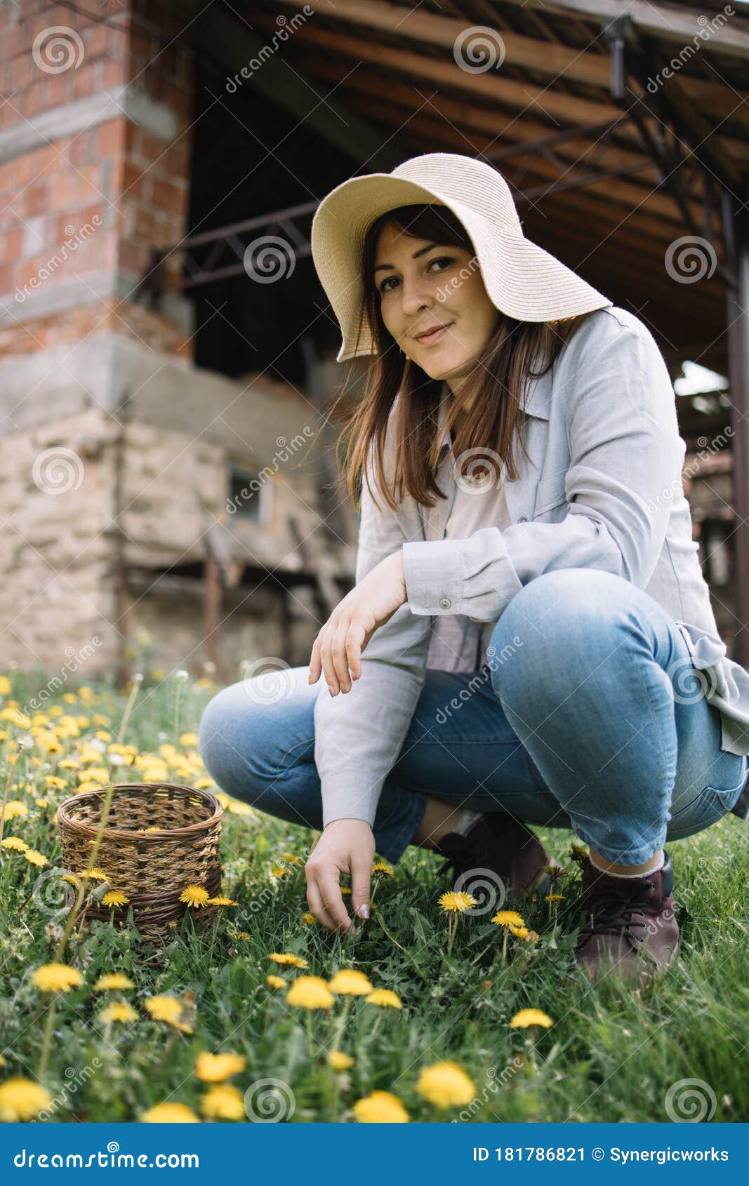 female-gardener-squatting-garden-dandelions-female-gardener-squatting-garden-dandelions-woman-wearing-sun-hat-181786821.jpg