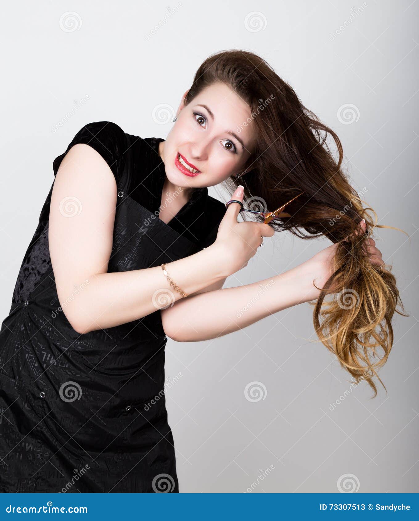 Female Hairdresser Trying To Cut Your Own Hair With Scissors Stock
