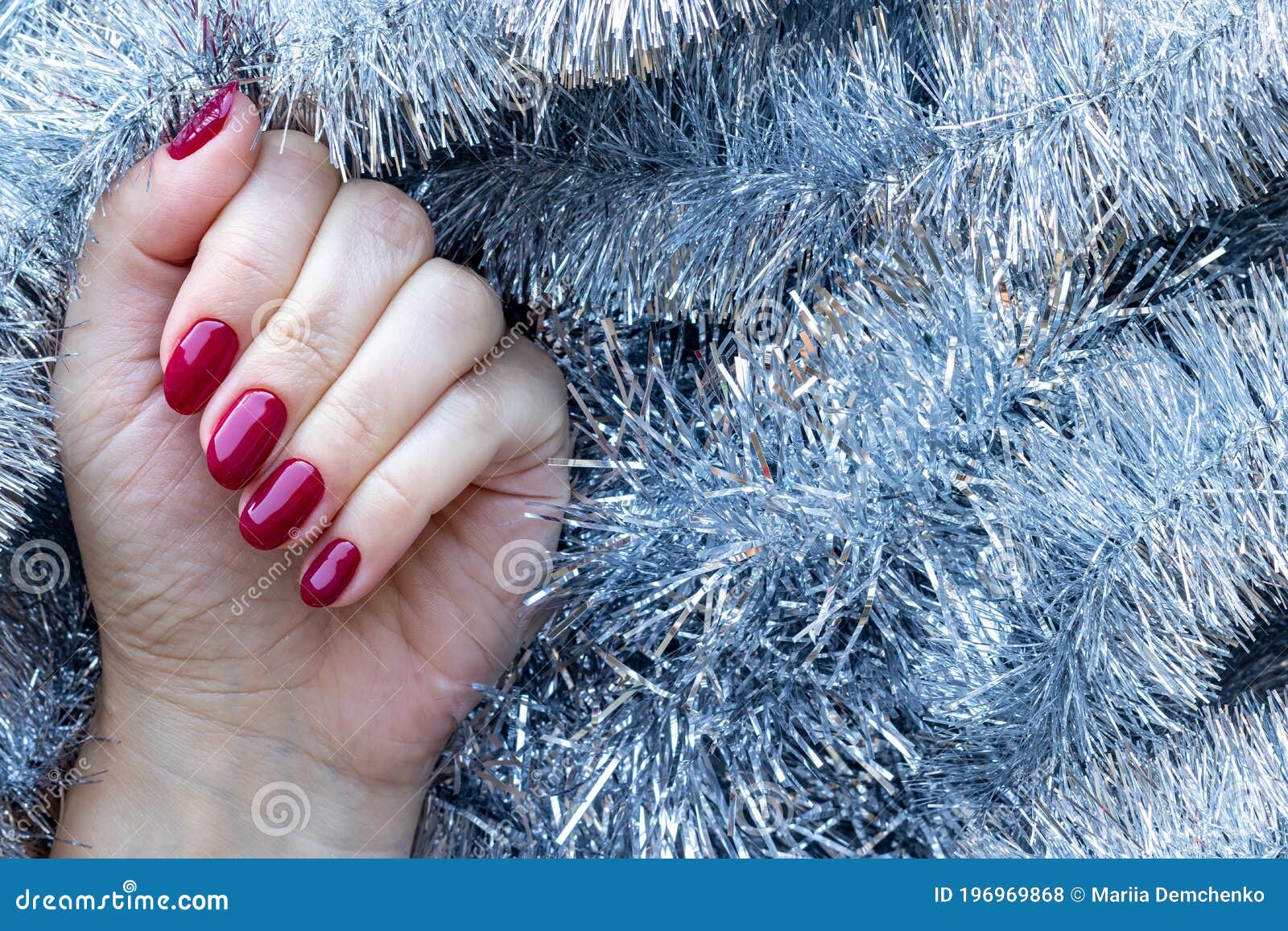 Female Hand with a Beautiful Glossy Manicure - Burgundy, Dark Red, Cherry  Color Nails on Background of Silver Christmas Tinsel Stock Photo - Image of  burgundy, care: 197056540