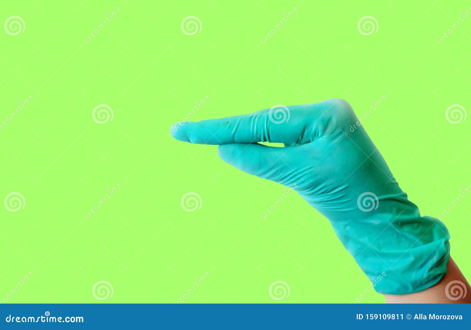 a female hand in a blue latex glove makes a gesture resembling a duck`s beak isolate on a malachite background. medical health