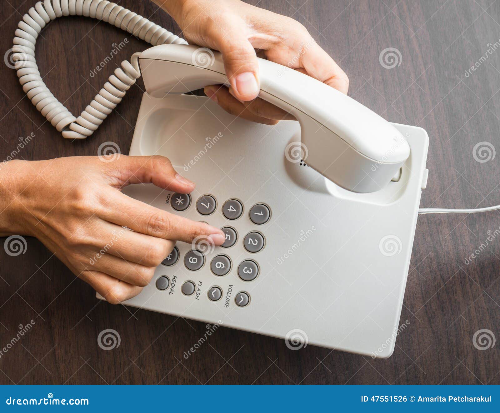 female hand dialling out on a telephone on keypad