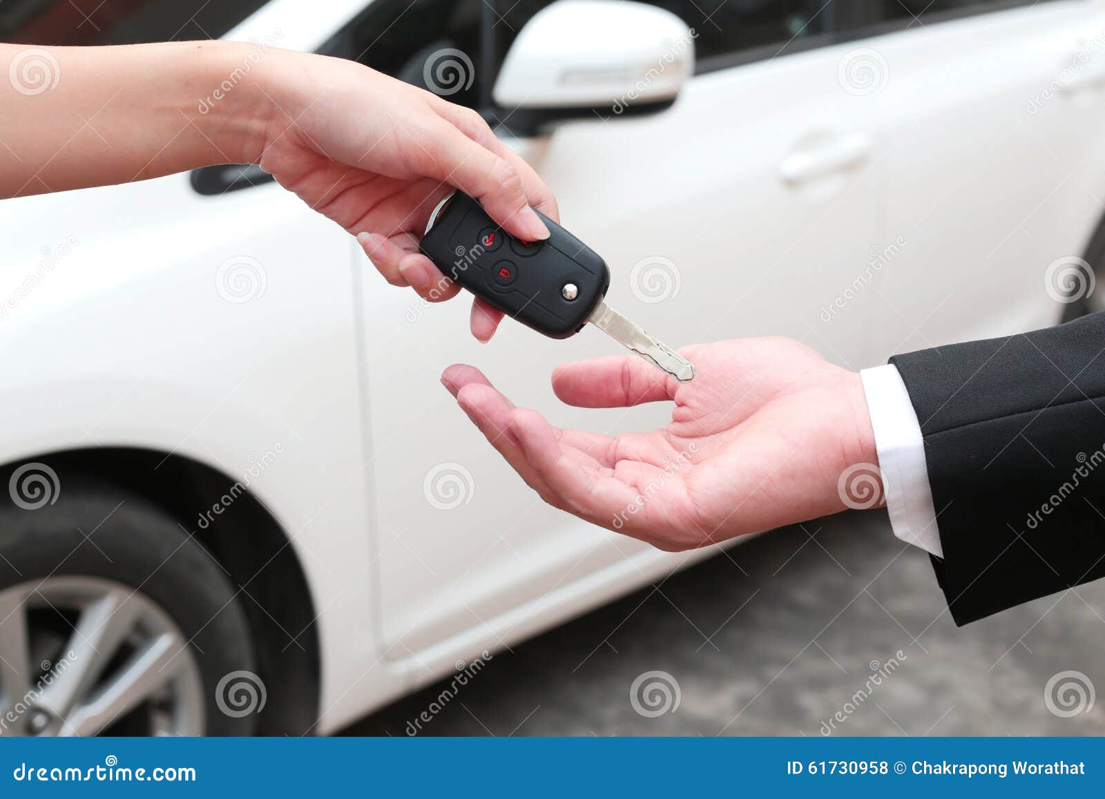 female hand giving a key for buyer or rental car.