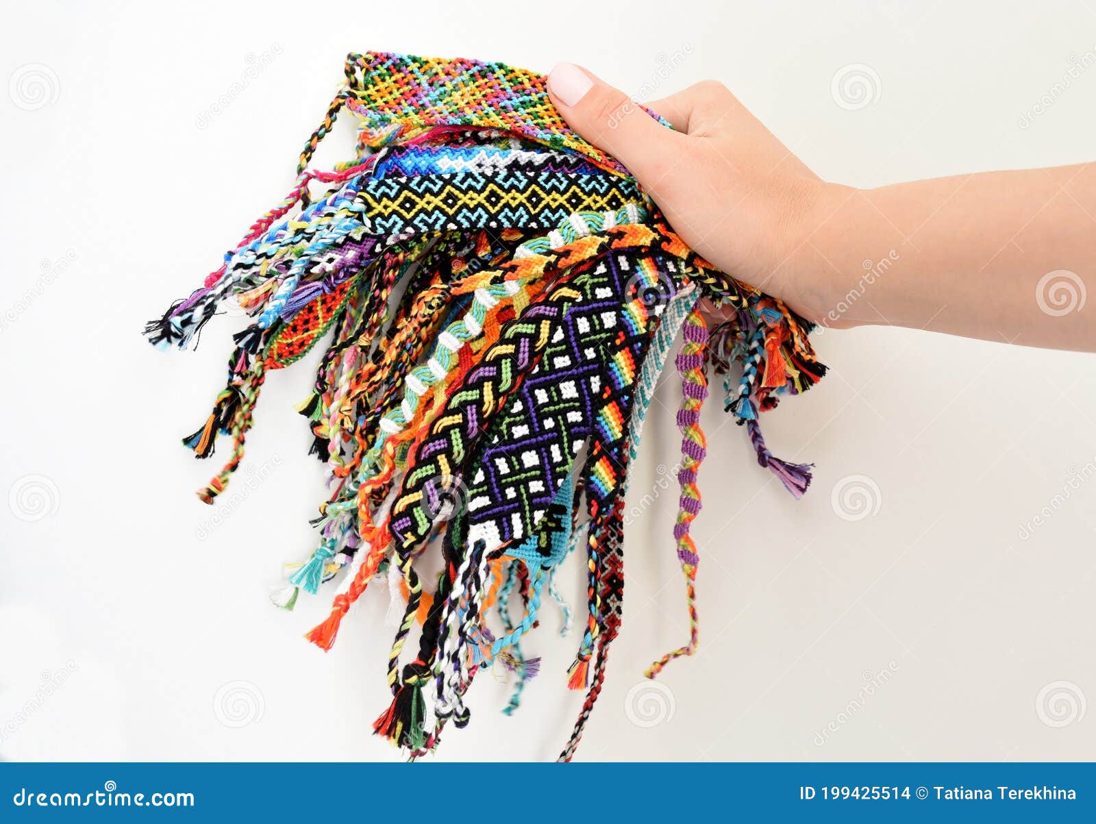 DIY friendship bracelets with Indian colorful pattern handmade of thread on  white background Stock Photo - Alamy