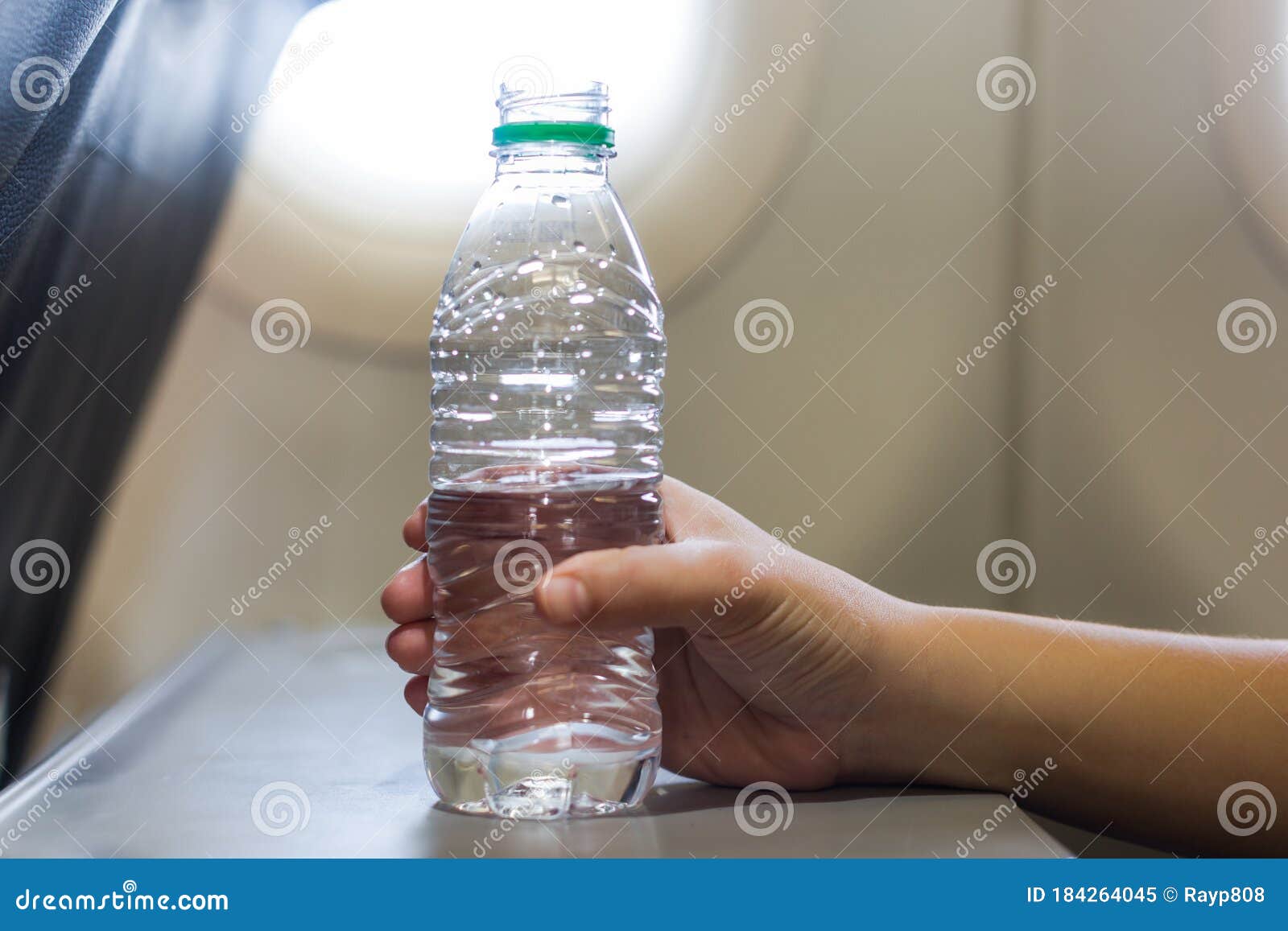 A Passenger Woman on a Airplane Flight Drinking a Bottle of Water Stock  Image - Image of hand, body: 184264045