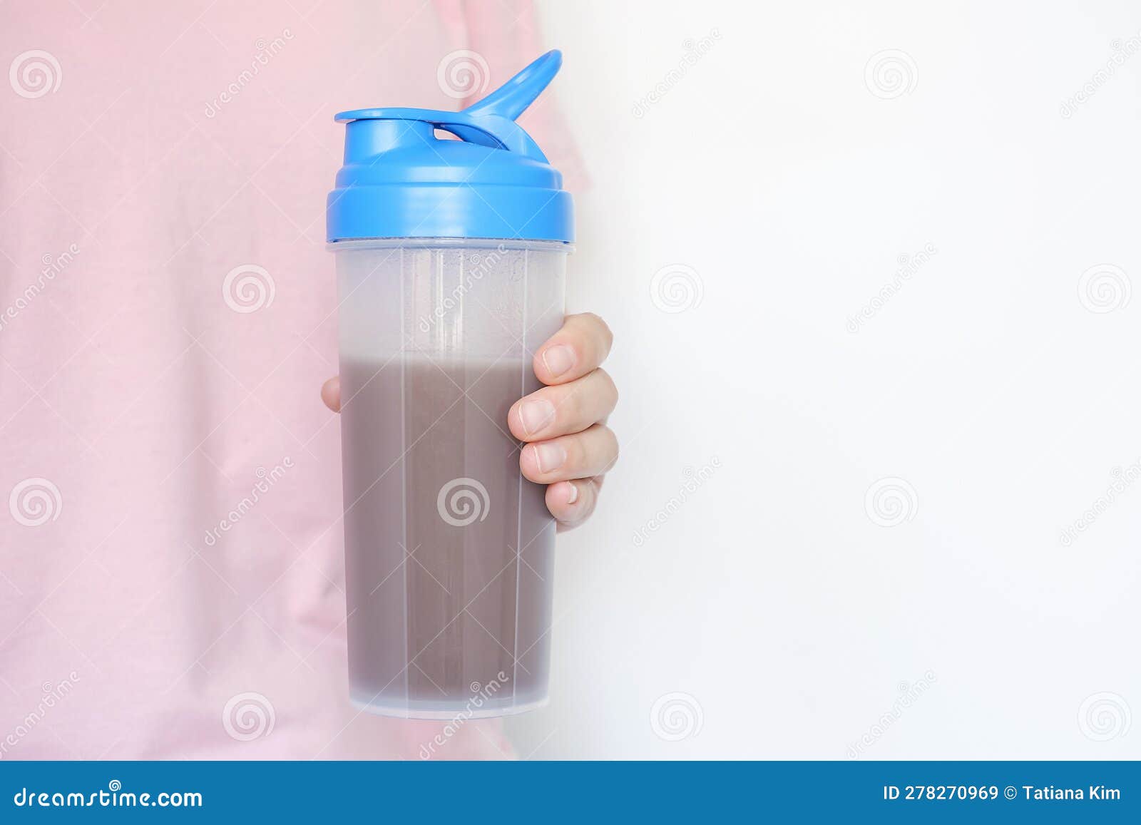 Female Hand Holds Shaker with Protein Shake on White Background. Stock