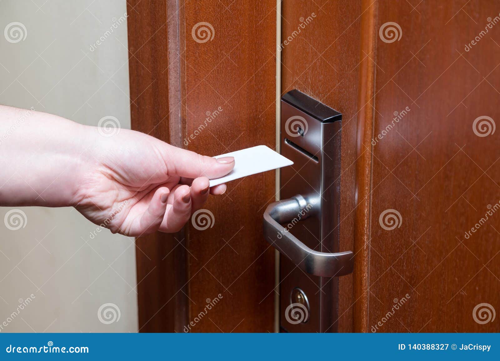 Female Hand Putting Key Card Switch In To Open Hotel Room