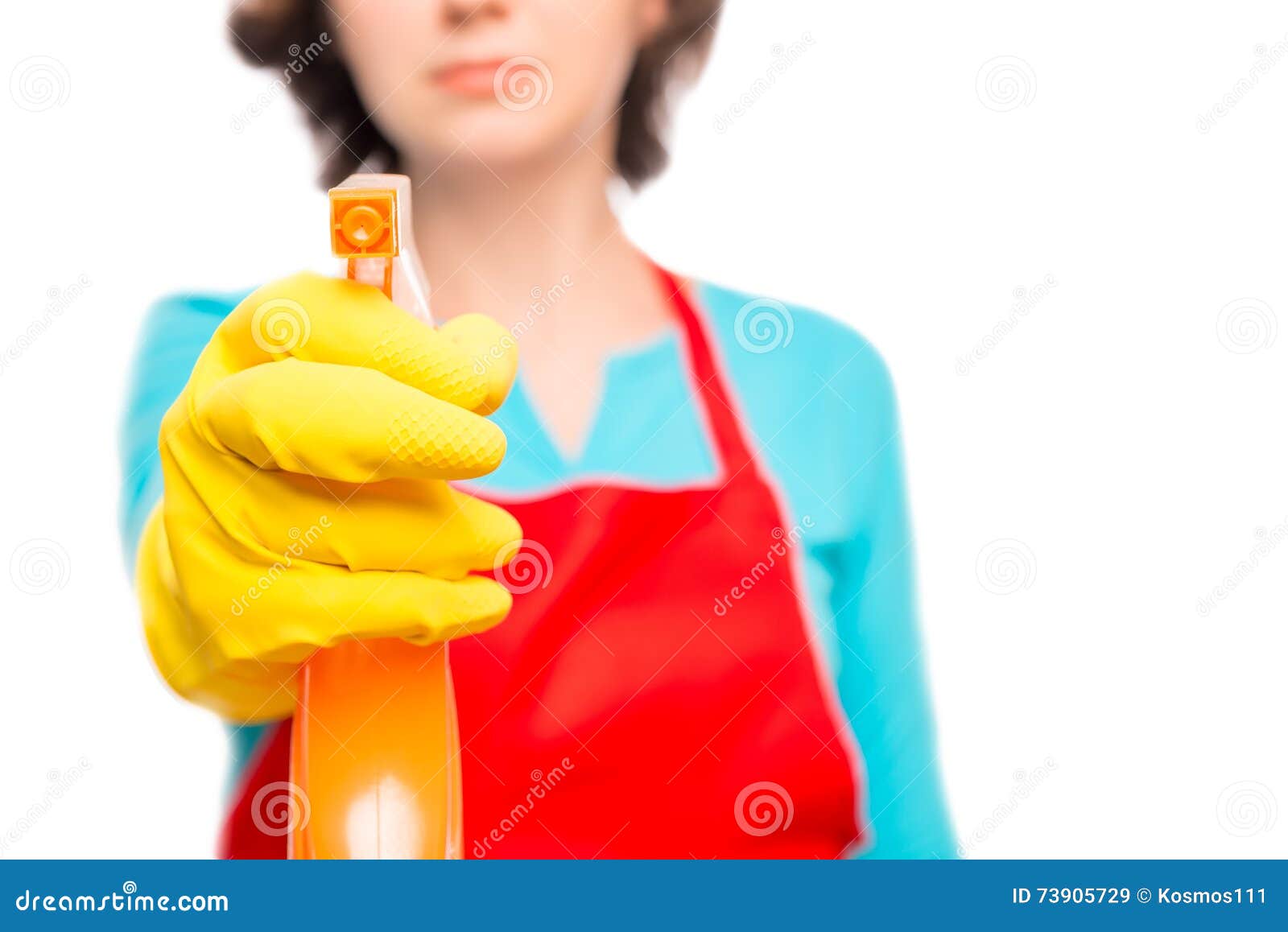 female hand in yellow glove directs the cleaning spray